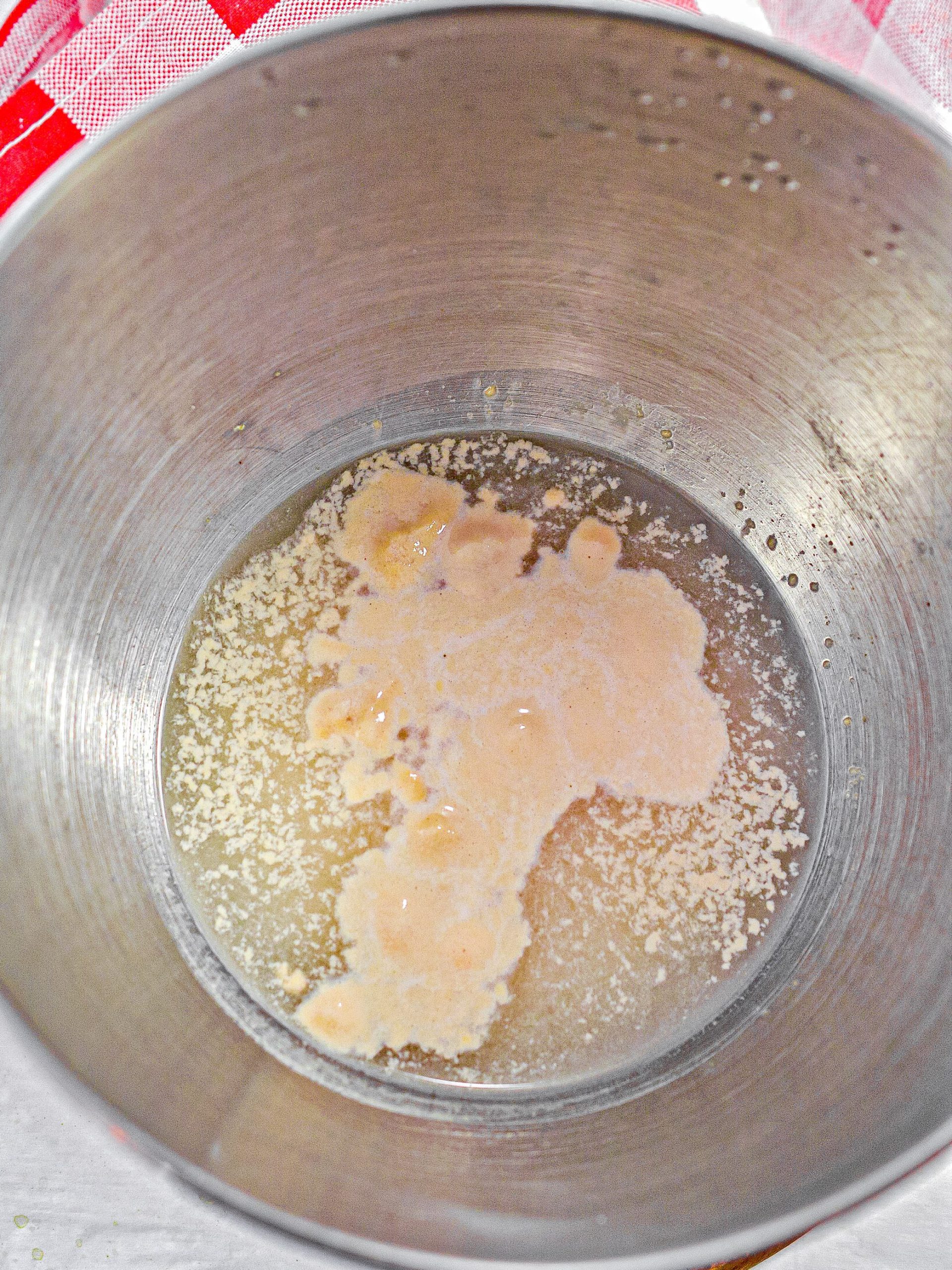 Add the yeast and water to a large mixing bowl and allow to sit to bloom for 10 minutes.