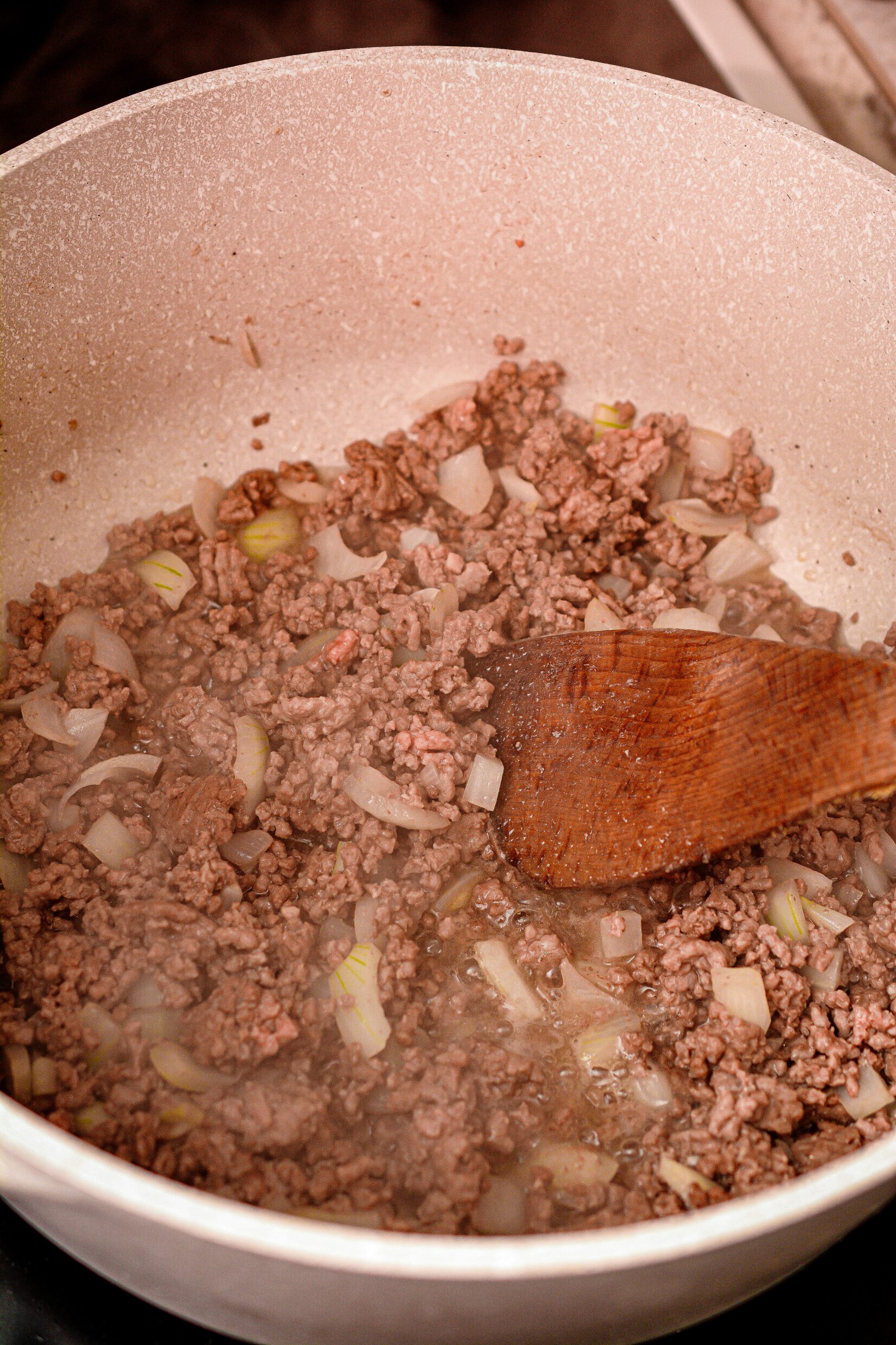 Add the ground beef and onion to a deep-sided saucepan over medium-high heat on the stove. Saute until the meat is browned and the onion is softened. Drain any excess fat.