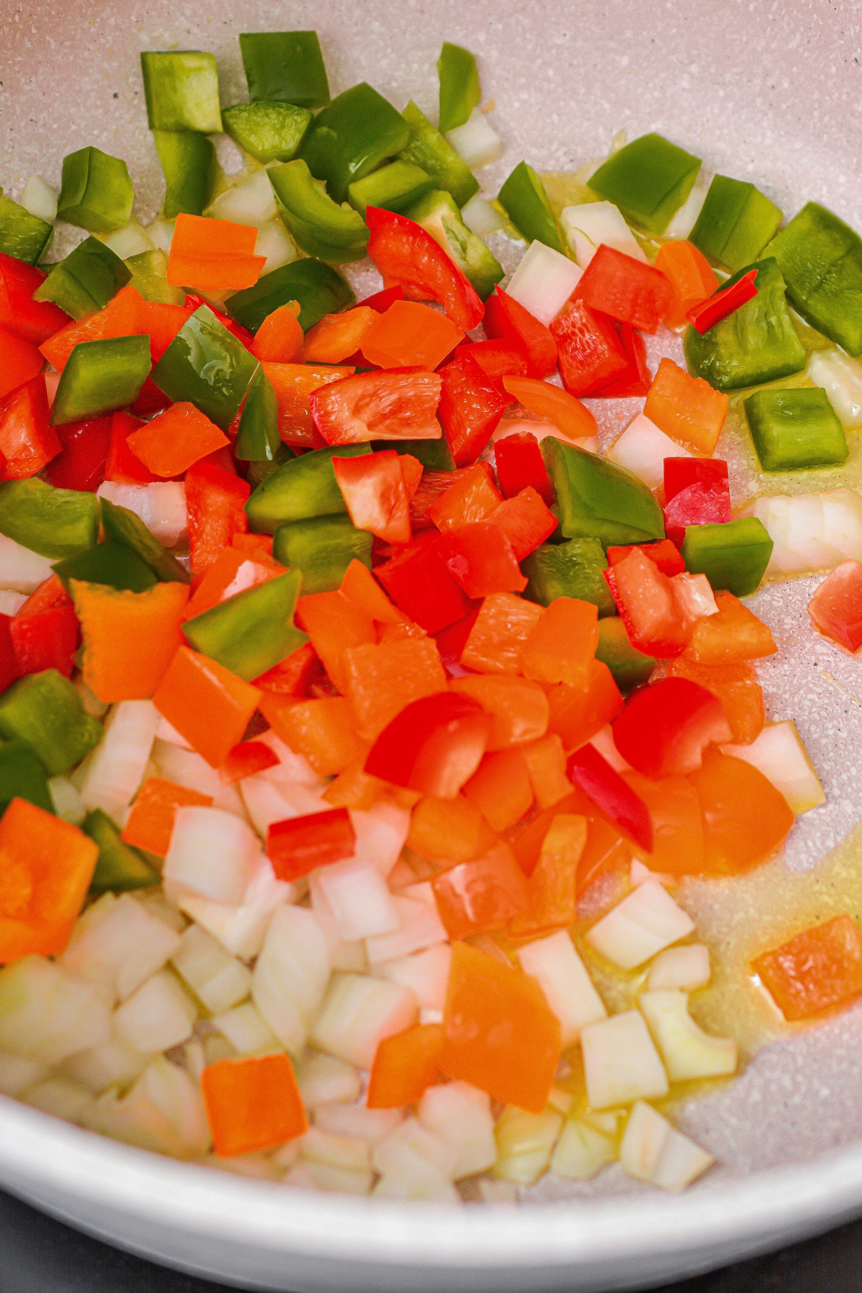 Add bell peppers to a skillet over medium-high heat on the stove.