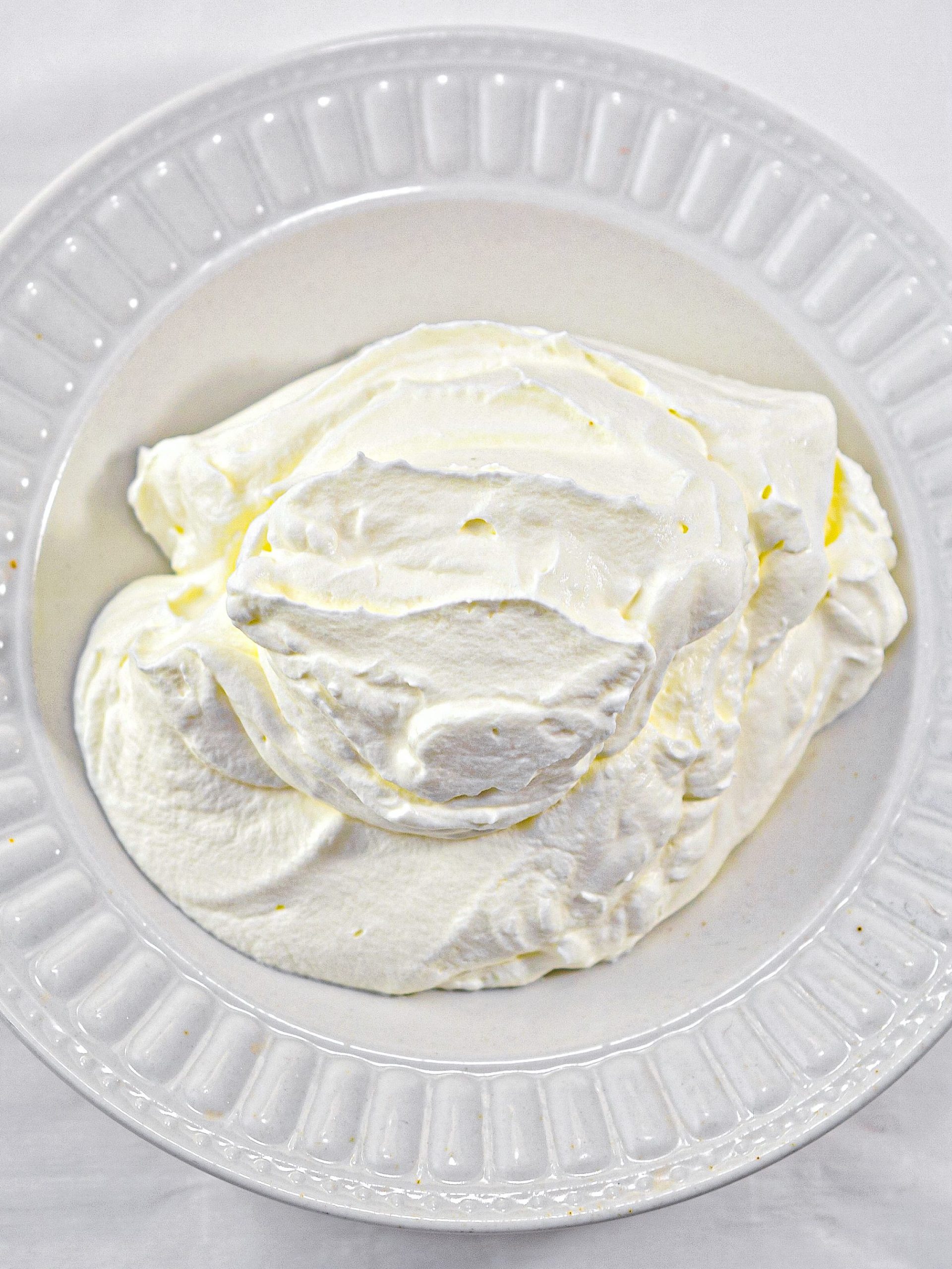 When ready, beat the heavy whipping cream in a mixing bowl until it forms stiff peaks, and set aside.