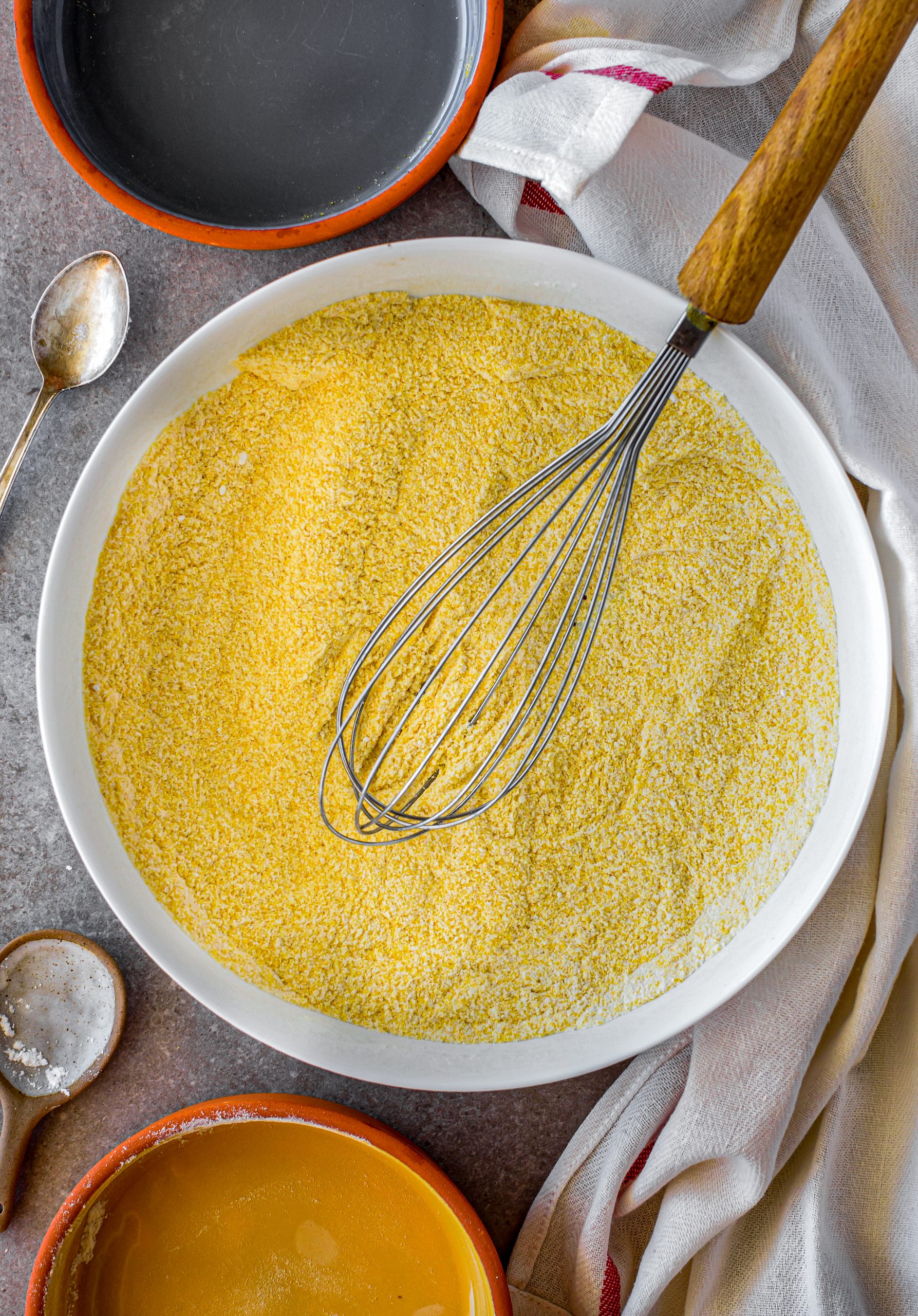 Mix together the sugar, flour, salt, baking powder, and cornmeal in a large bowl. 