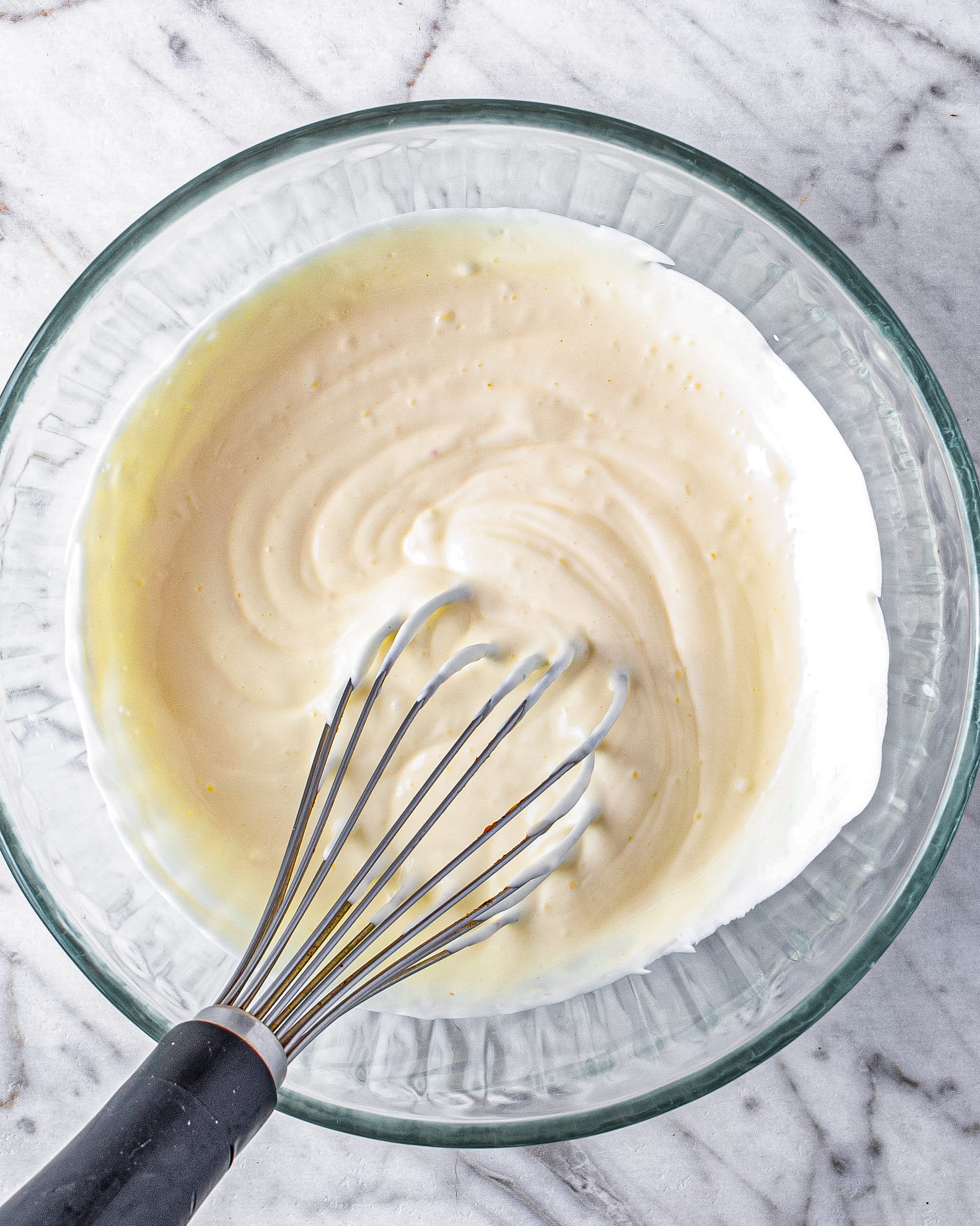 Using a large bowl, whisk together the mayo and sour cream.