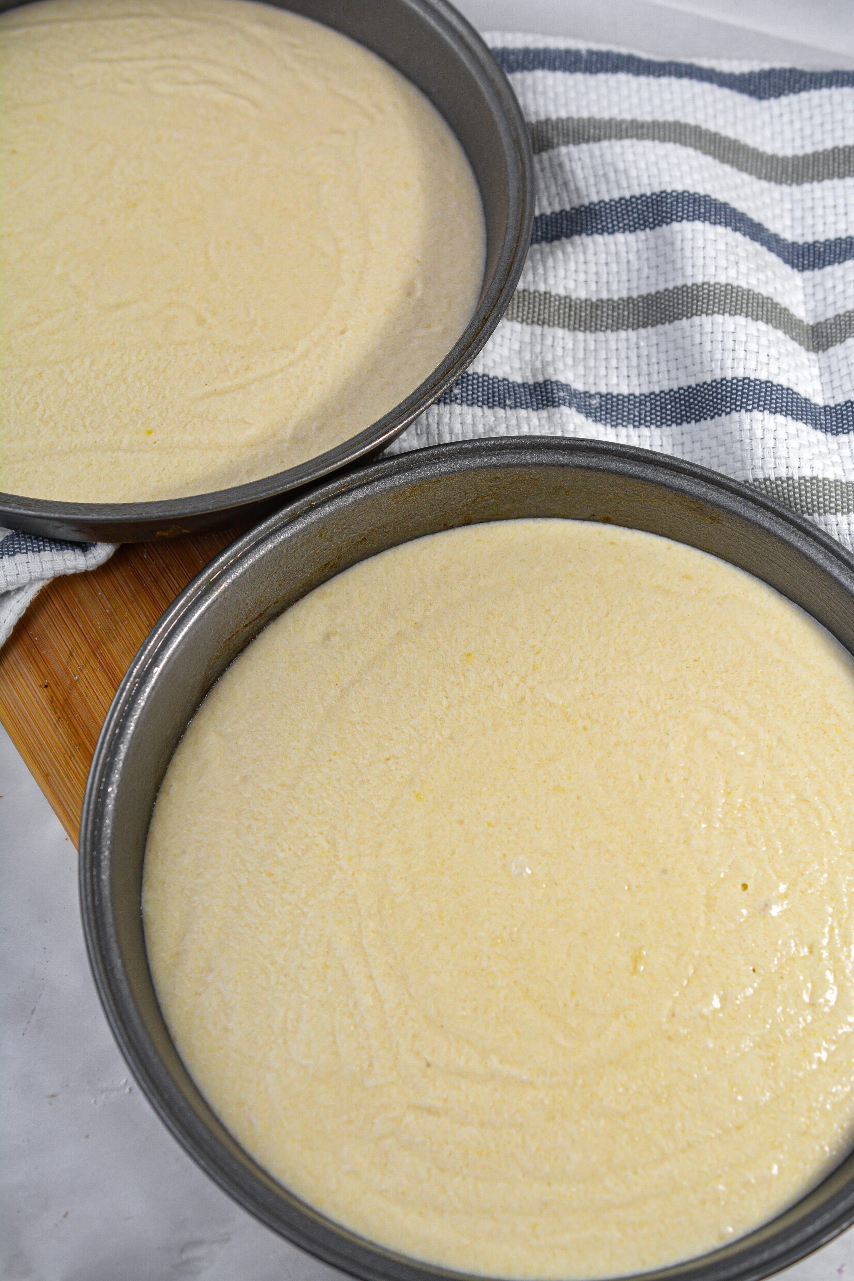 Separate the batter evenly between the two cake pans.