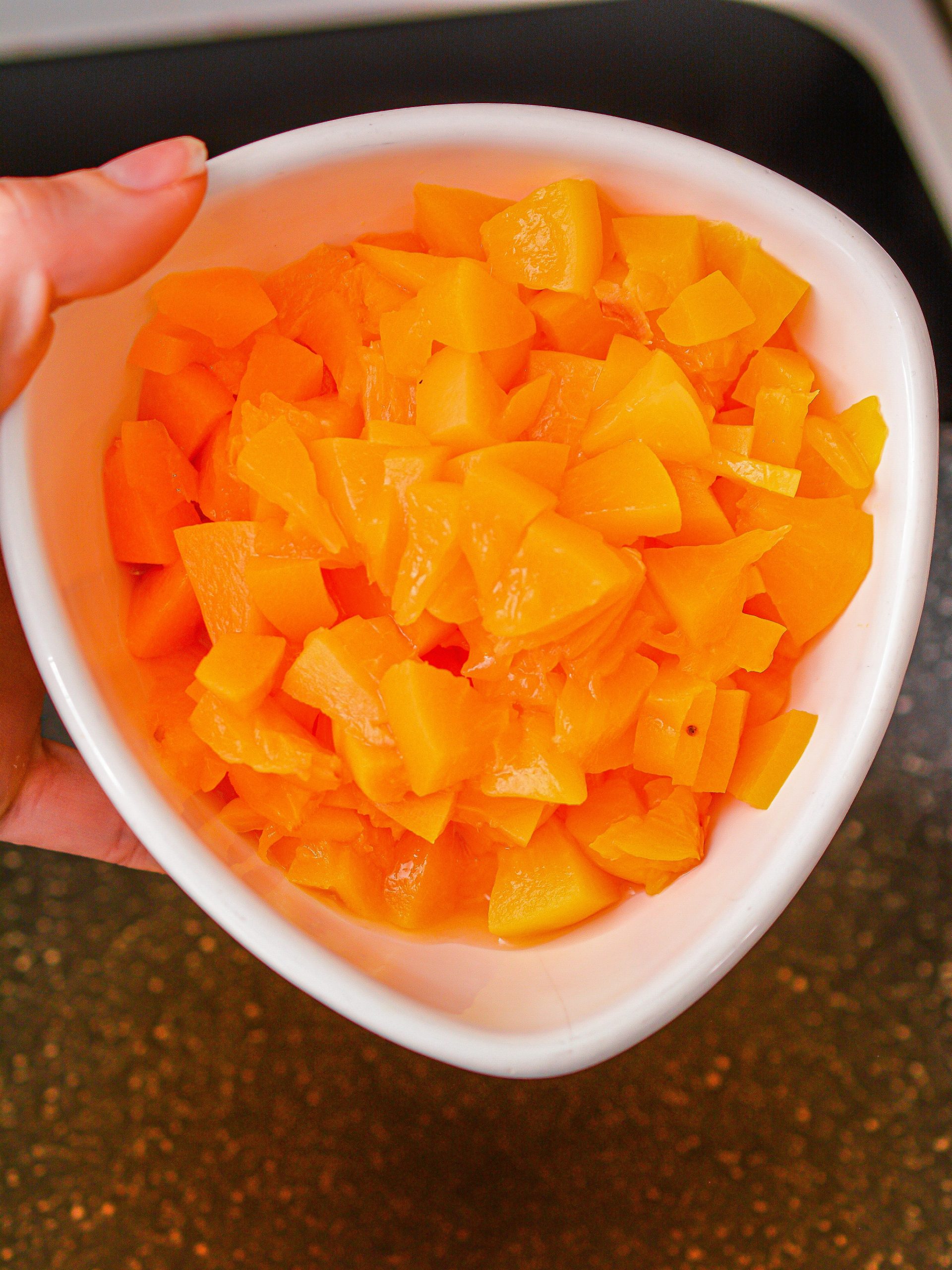 Dice the peaches and add them to a skillet over medium-high heat on the stove.