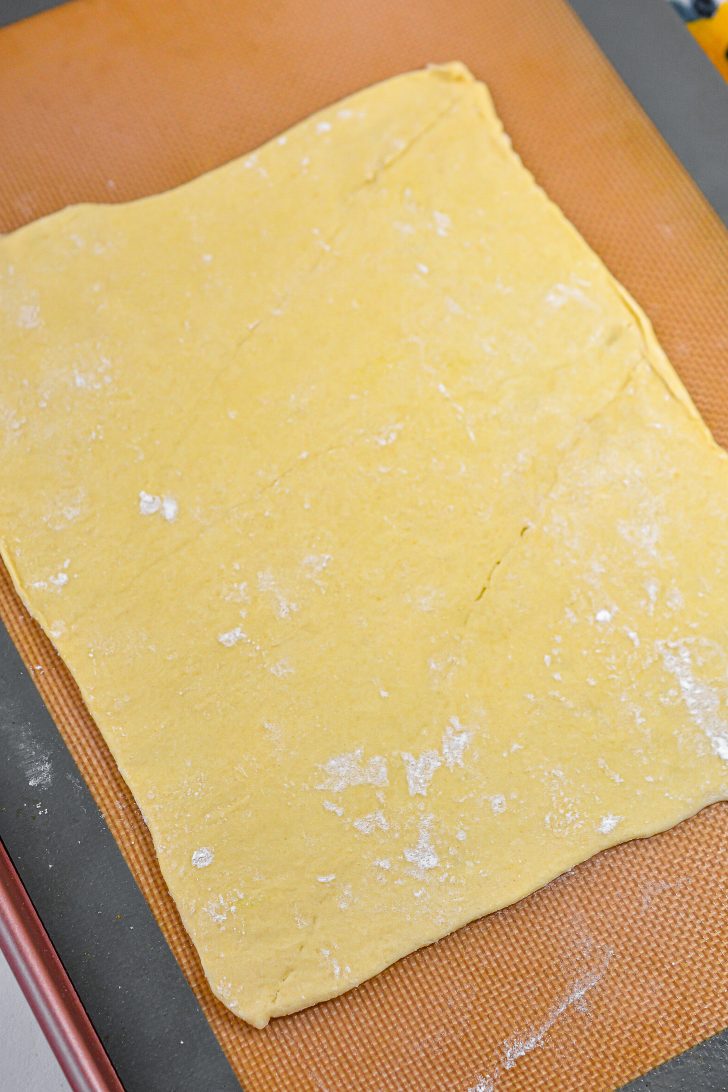 Roll half of the dough out until it is a rectangle about 12 inches long.