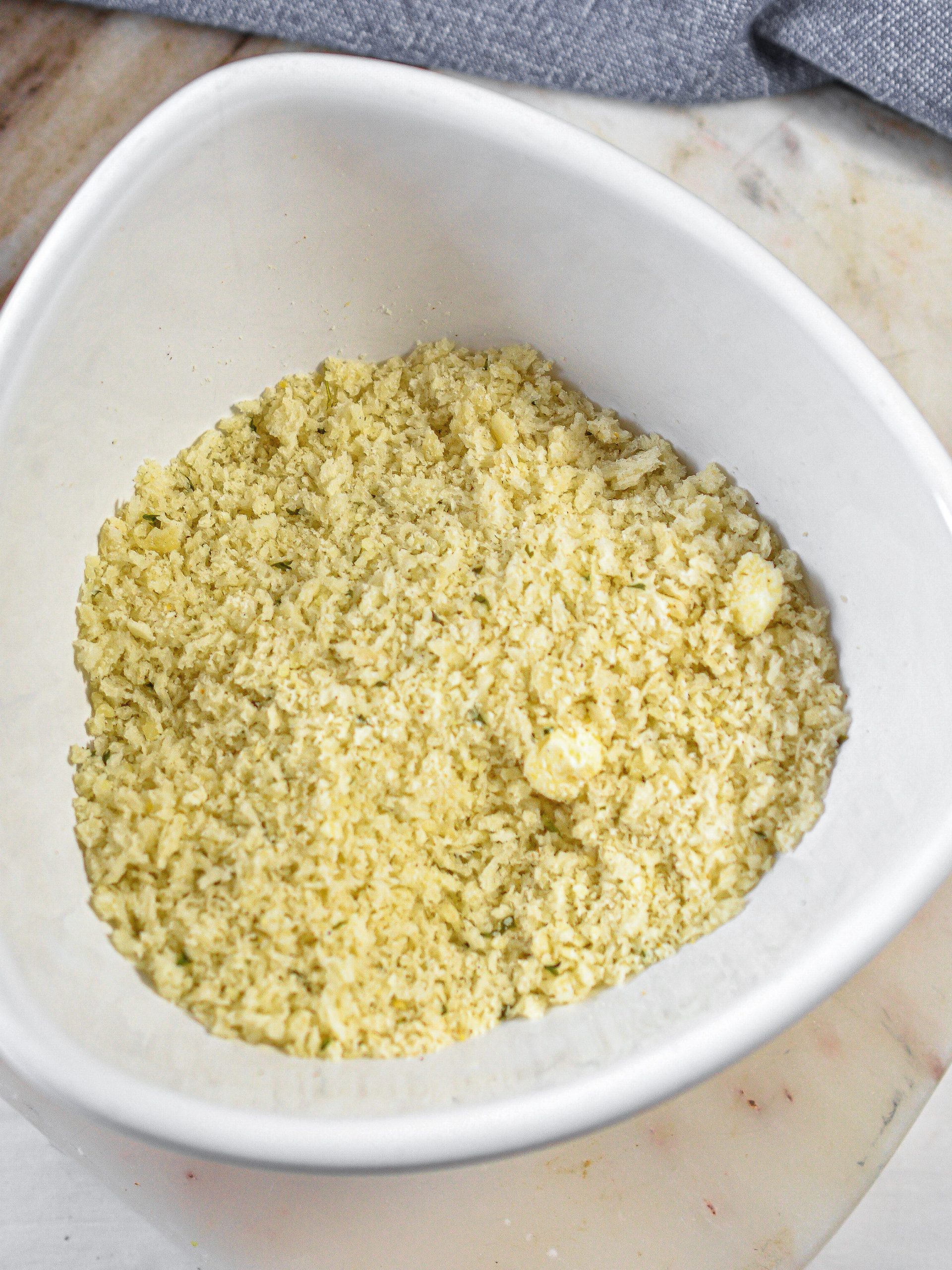 In a bowl, combine the breadcrumbs and parmesan cheese.