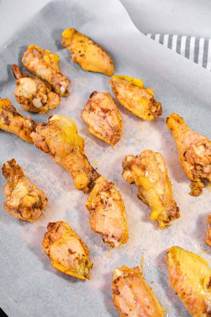 Remove the chicken wings and place them onto a baking sheet.