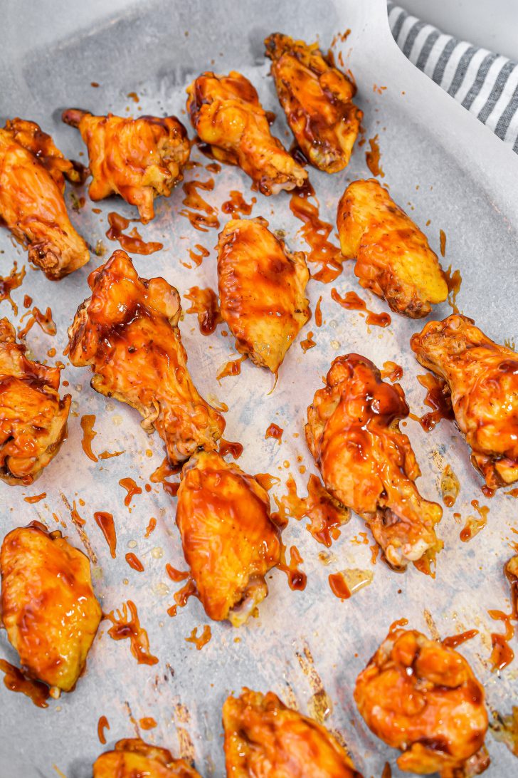 Brush the chicken wings with BBQ sauce on both sides.