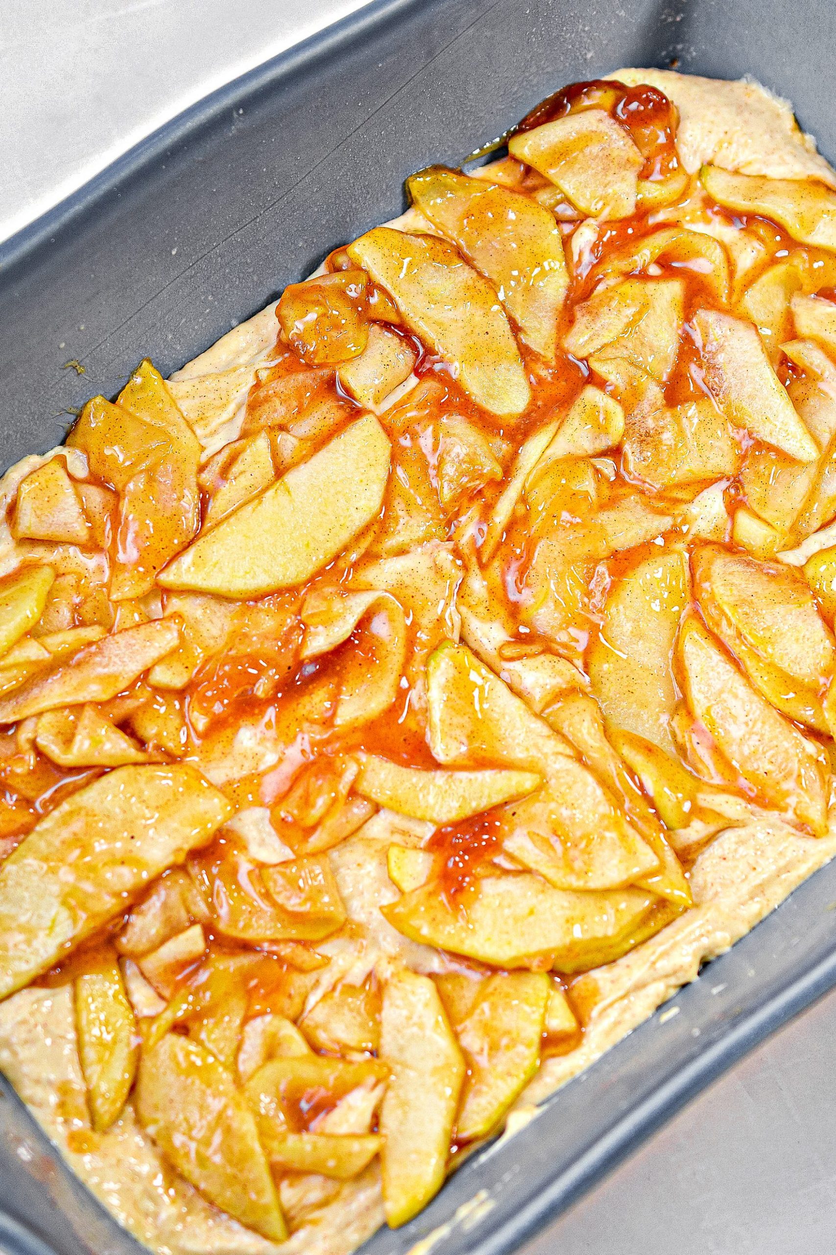 Cover the batter with the apple filling, and sprinkle ¾ of the brown sugar mixture on top of them.