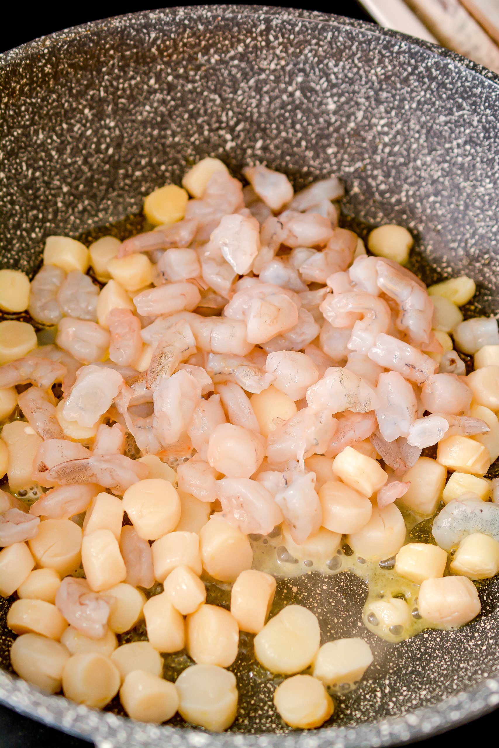 Add the shrimp, and scallops to the skillet. 