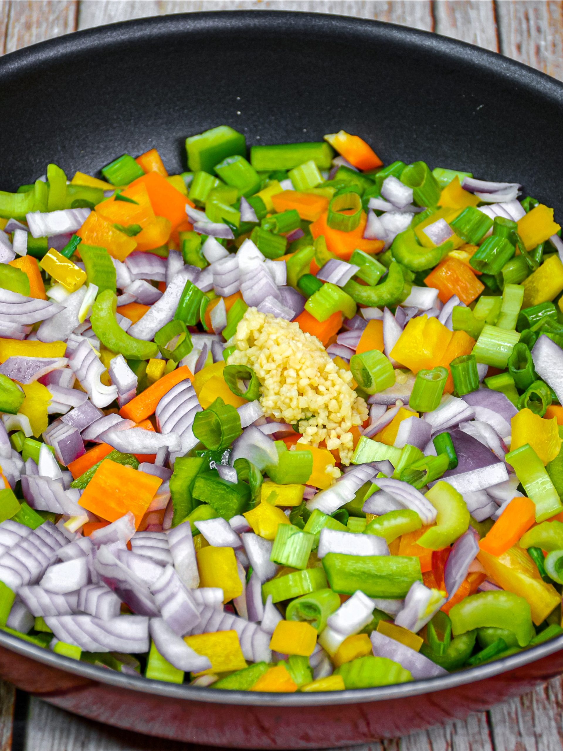 Add the onions, peppers, minced, garlic and celery to the saute pan.