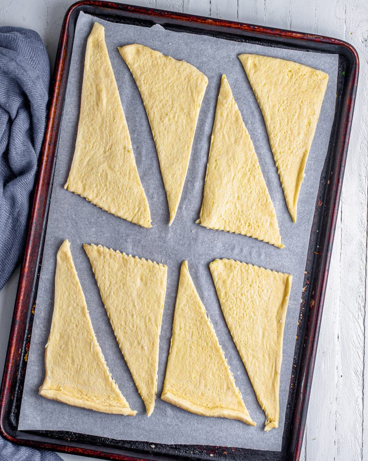 Unroll the crescent roll dough, and separate each triangle individually. 