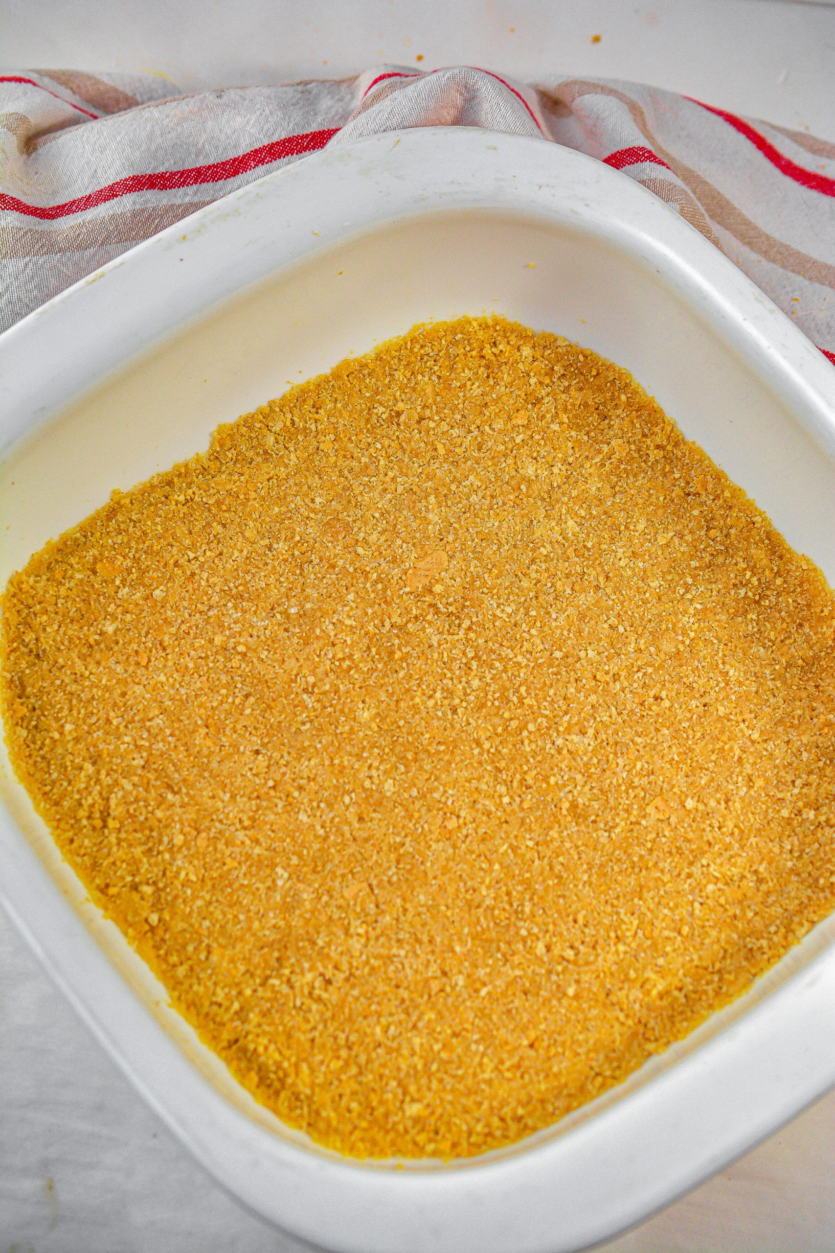 Press the crust mixture into the bottom of the greased baking dish, and bake for 15 minutes.