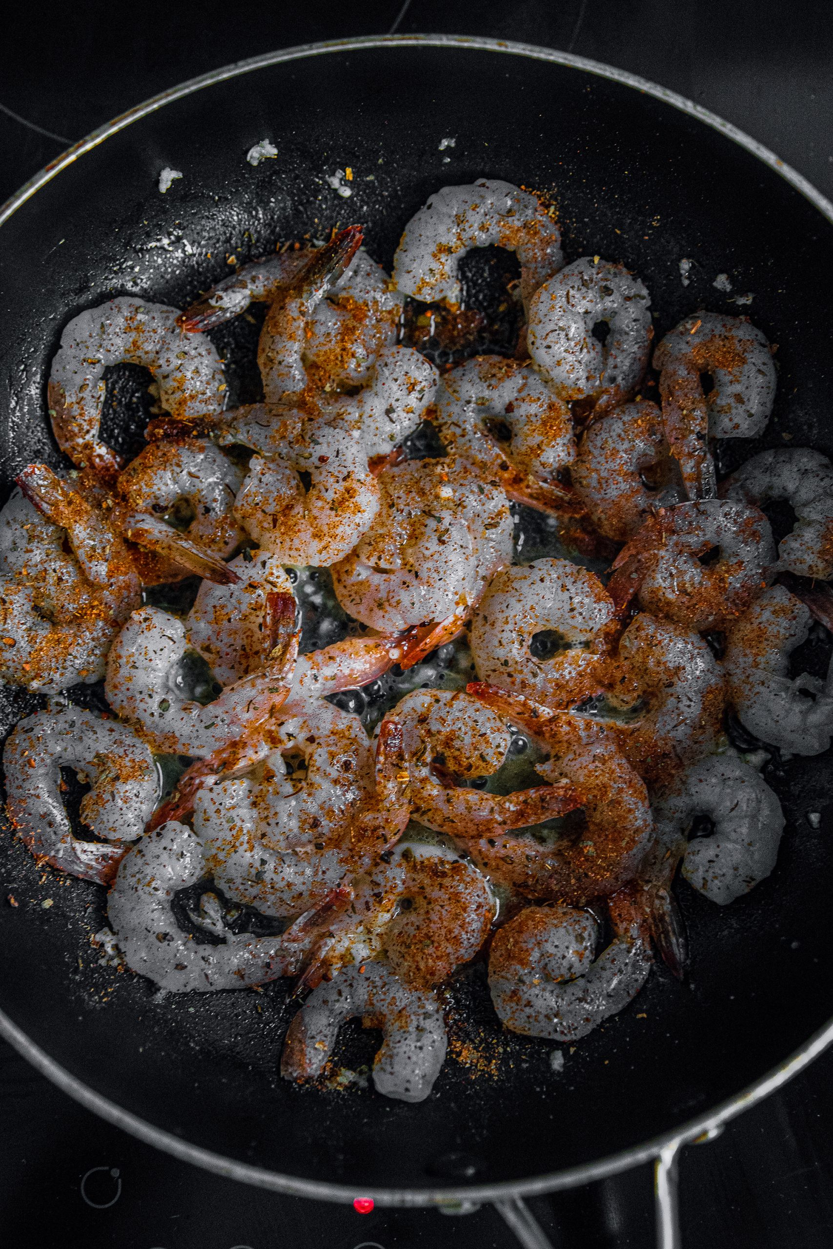 Next, season the shrimps with the Cajun seasoning., be generous (to your liking)!