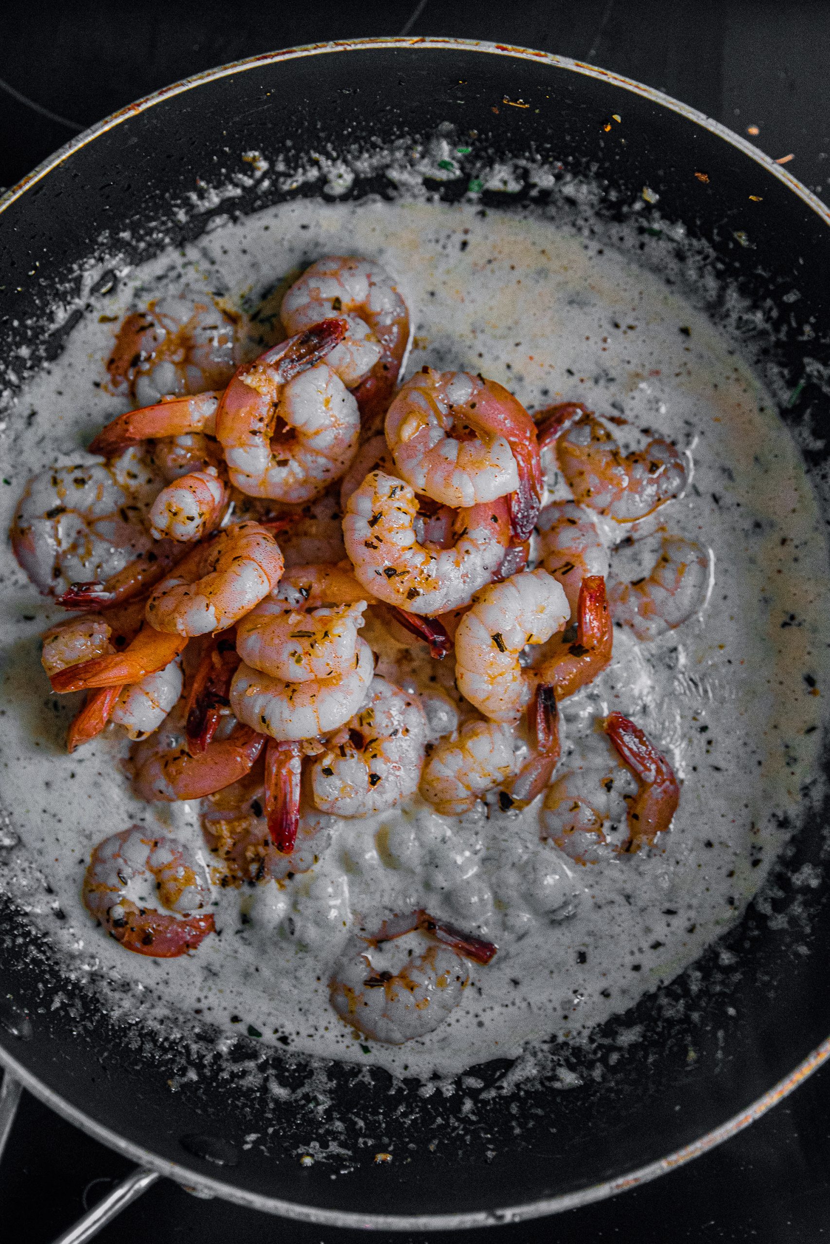 Lower heat to medium-low and add shrimp again.