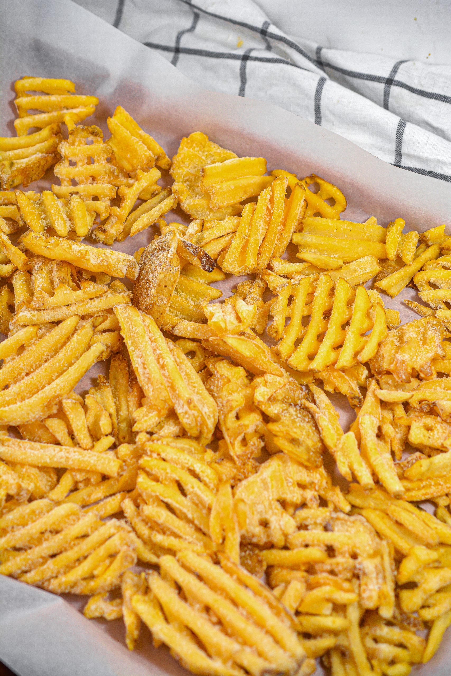 Cook the waffle fries on a parchment-lined baking sheet for 20-25 minutes, or until crispy. 