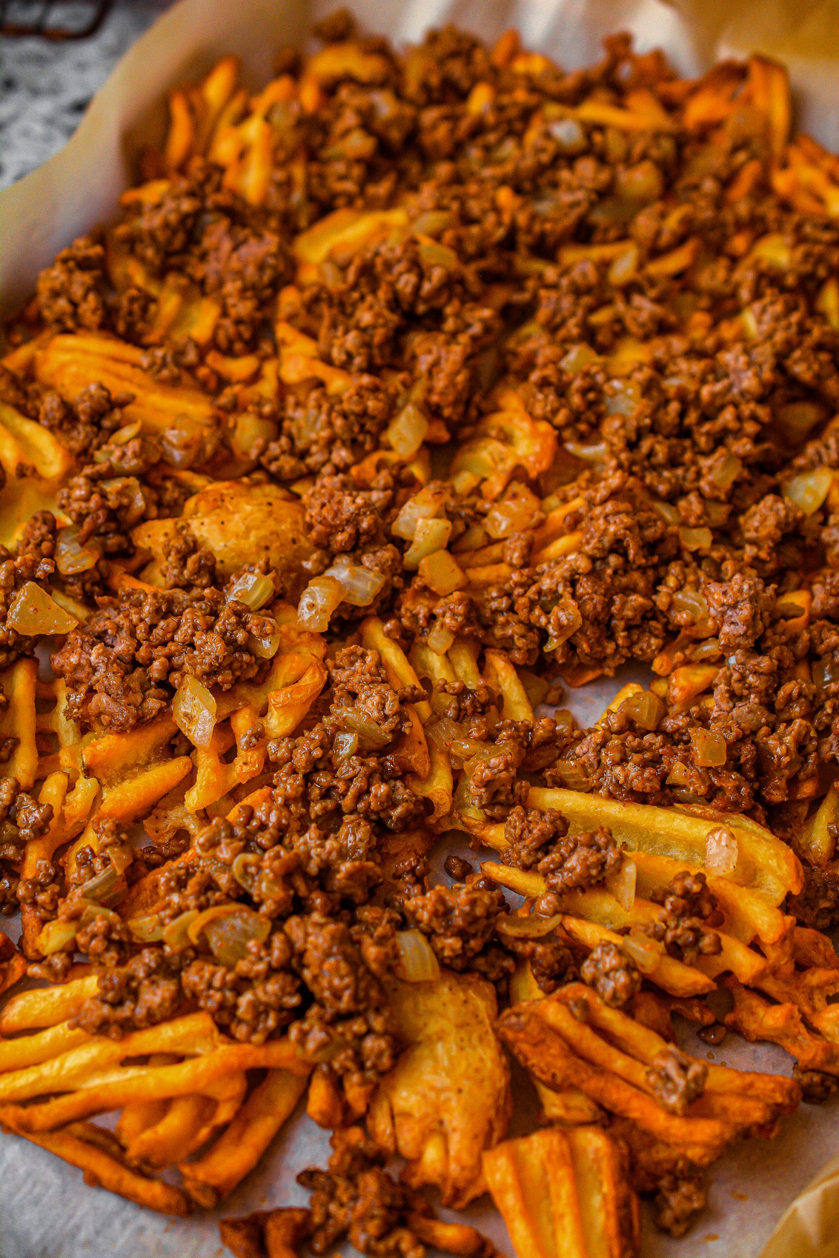Top the fries with the beef mixture.