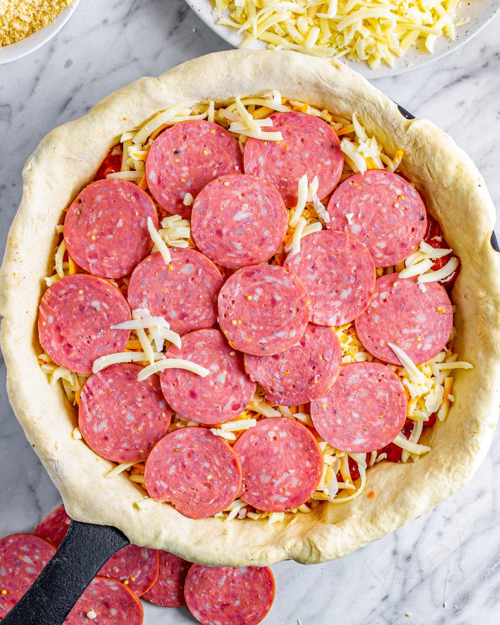 Place an even layer of pepperoni on top of the cheese.