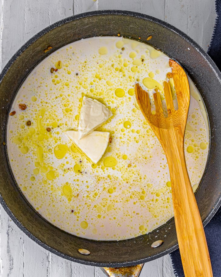 Stir the cheese wedges into the skillet until melted, and then pour in the half and half and chicken broth. Whisk to combine well. 