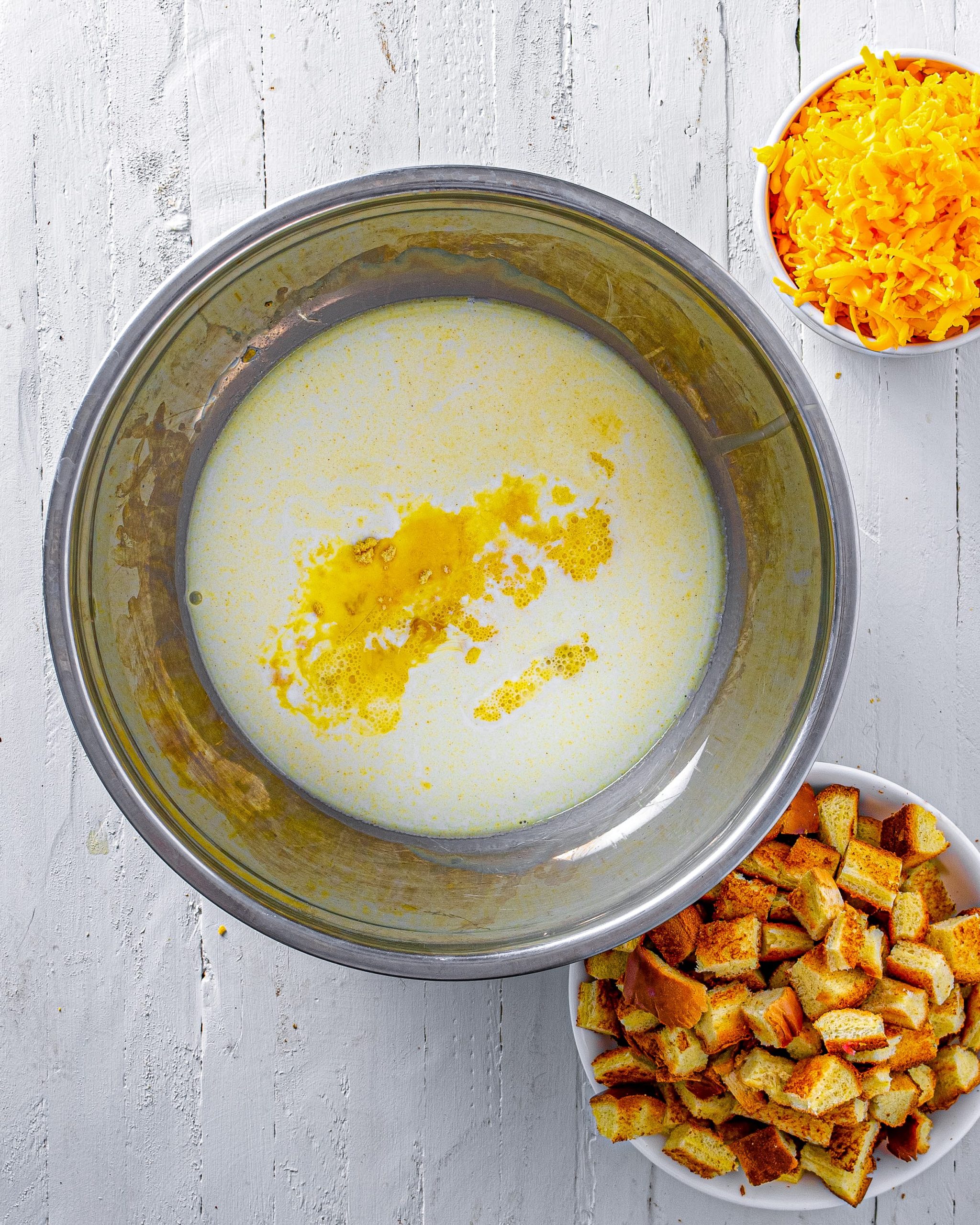 In a medium bowl, mix together mustard powder, salt, eggs, and milk.
