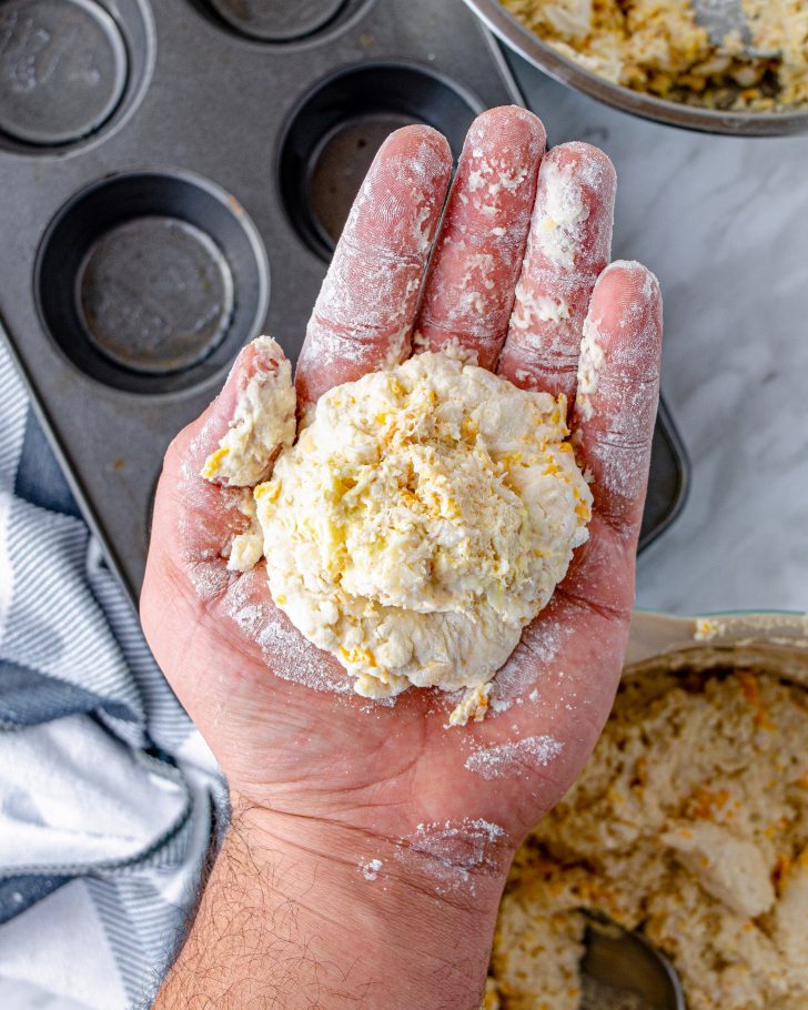 Flour your hands lightly. Add a bit of the biscuit mix to your hand, and form it into the shape of a bowl. 