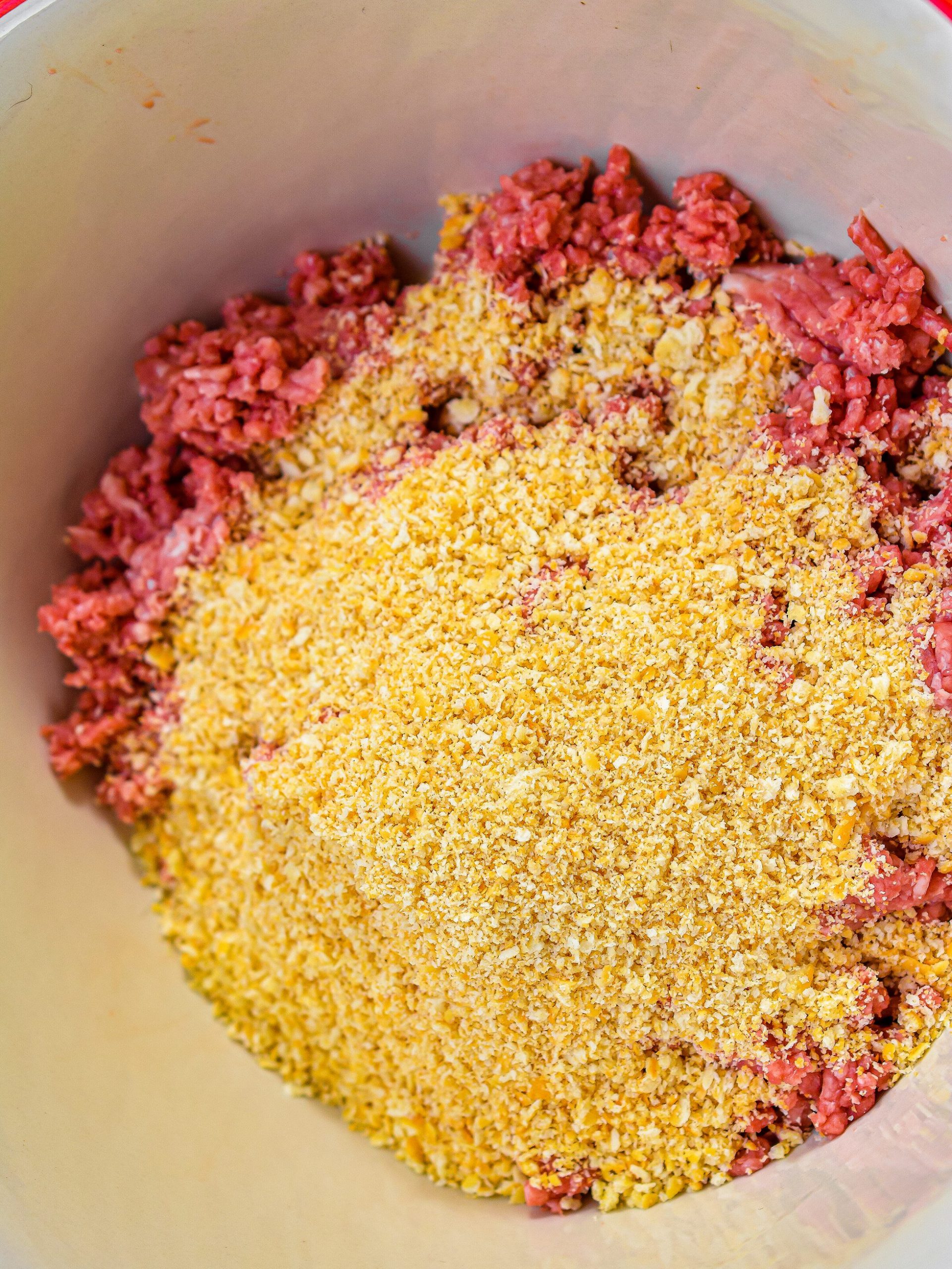 In a mixing bowl, combine 2 lbs ground beef and 25 ritz cracker crumbs.