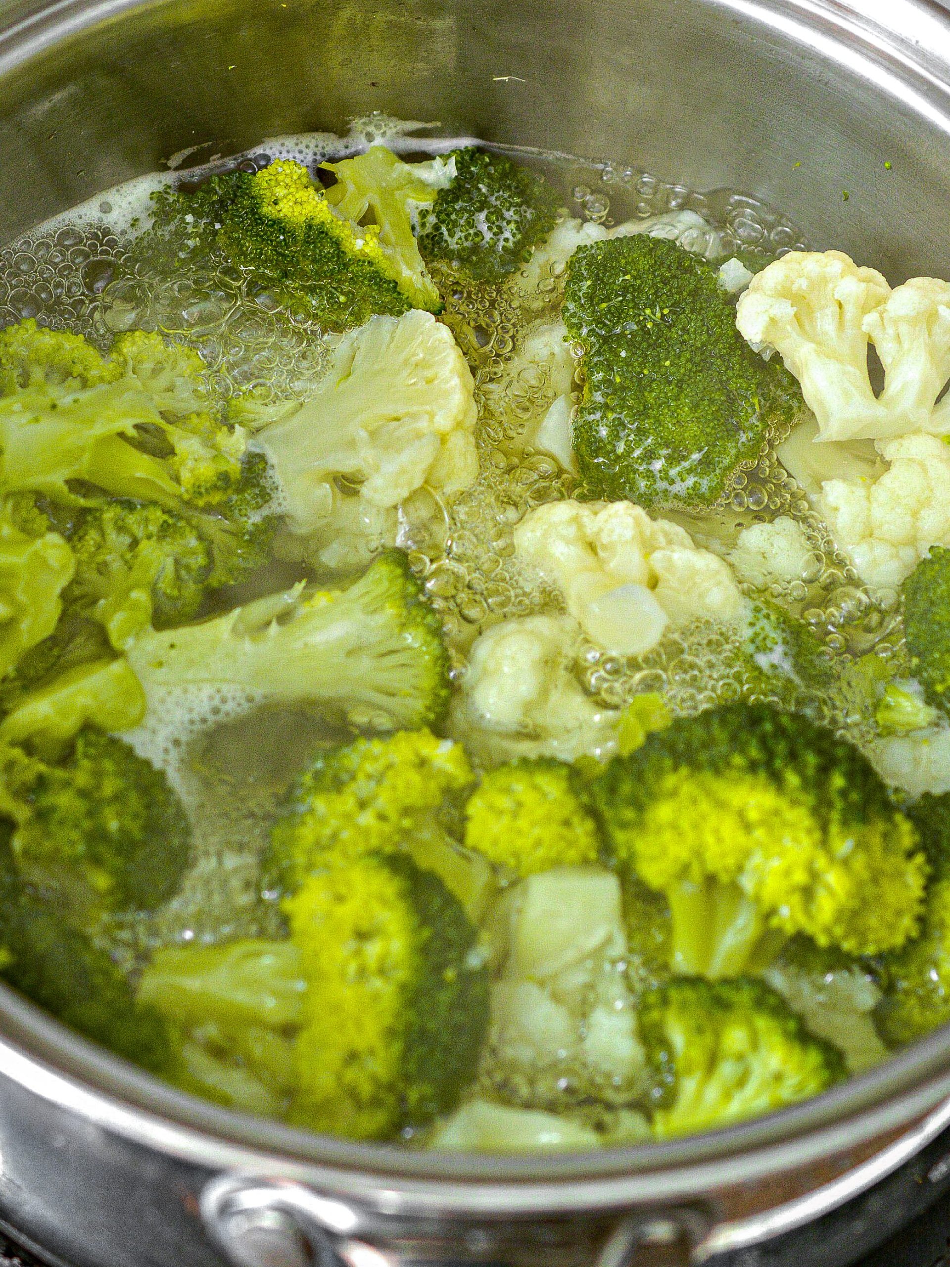 Place the cauliflower and broccoli florets into a pot with water, and bring to a boil on the stove.
