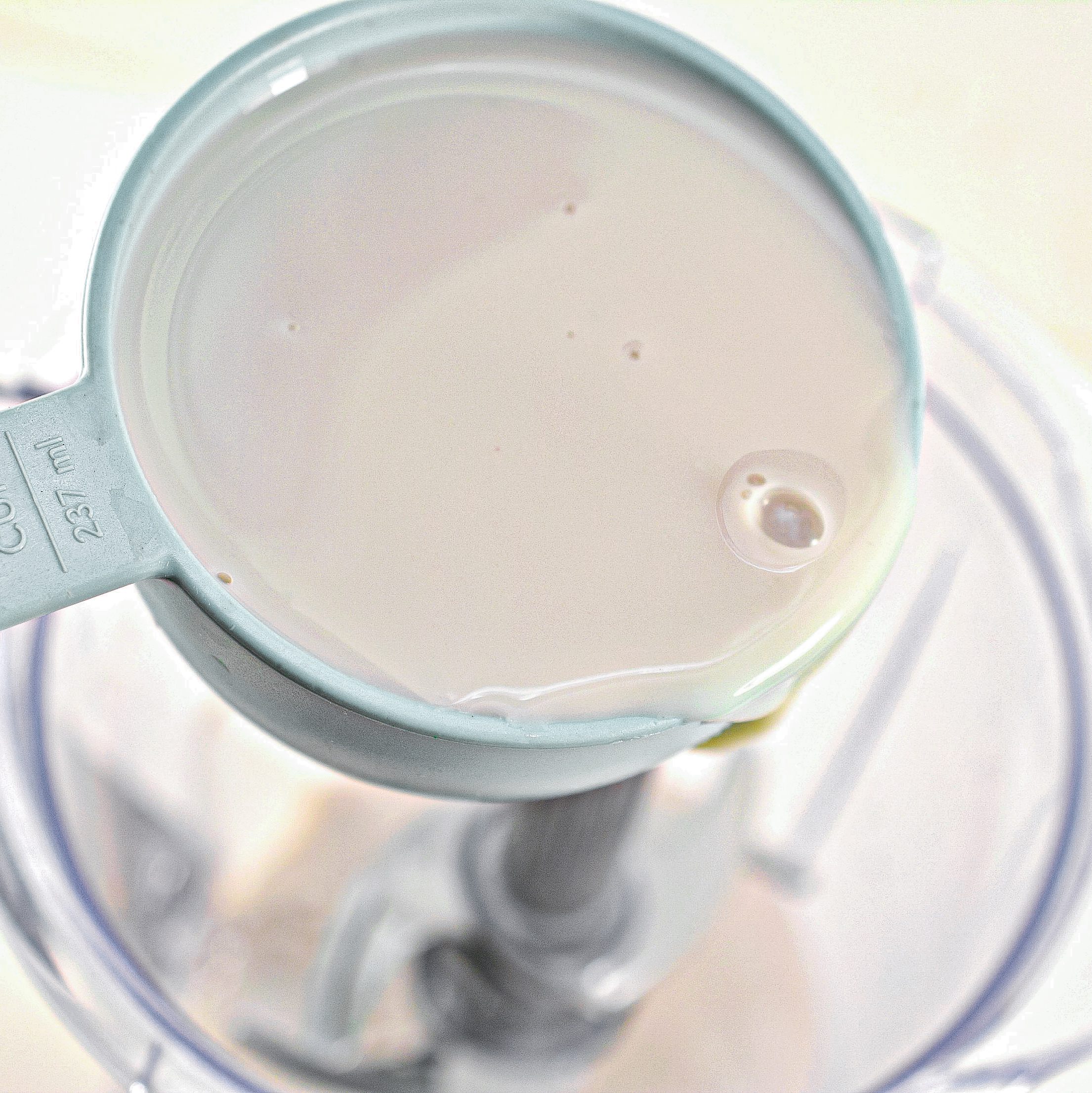 Place 2 cups of unsweetened almond milk into a blender or food processor.
