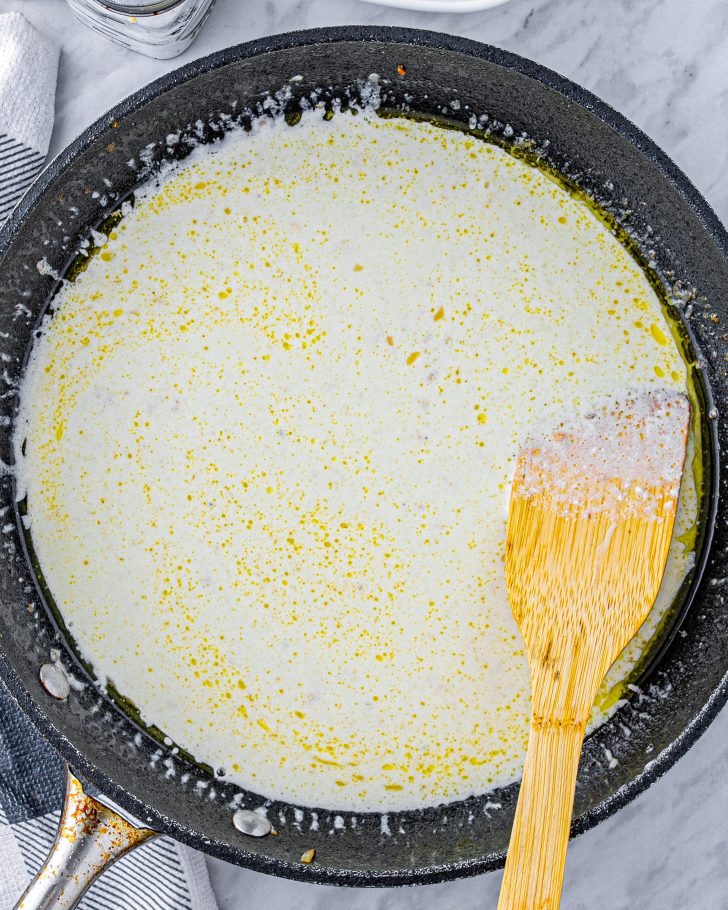 Whisk the heavy whipping cream into the skillet