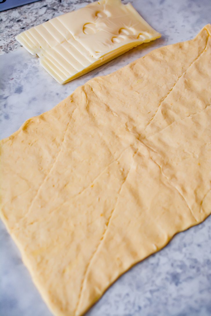 Roll the crescent roll dough out on a parchment-lined surface