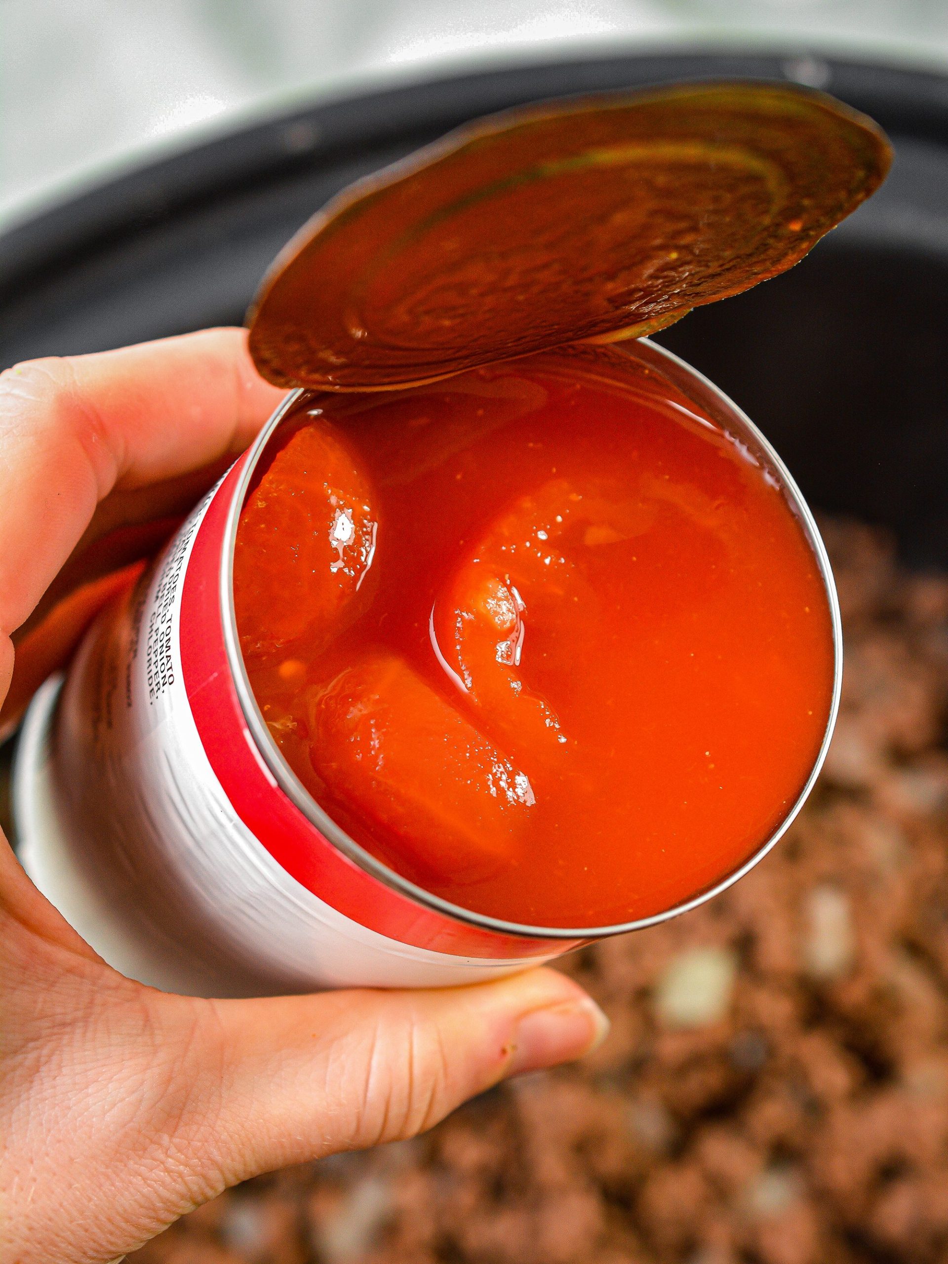 Cover the meat mixture with a 15 oz can of stewed tomatoes.