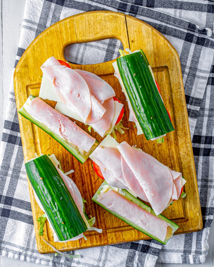 Roll up the remaining slices of meat, and layer them on the second halves of the cucumber slices. 