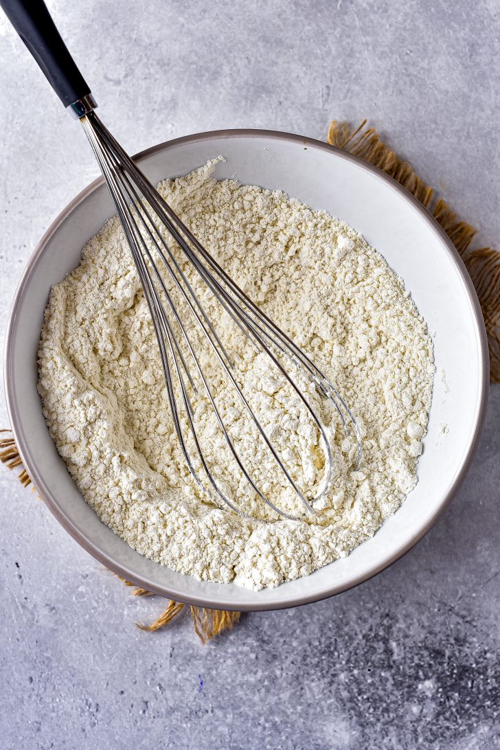 In a medium bowl, whisk together the flour, baking powder, baking soda, and salt; set aside.