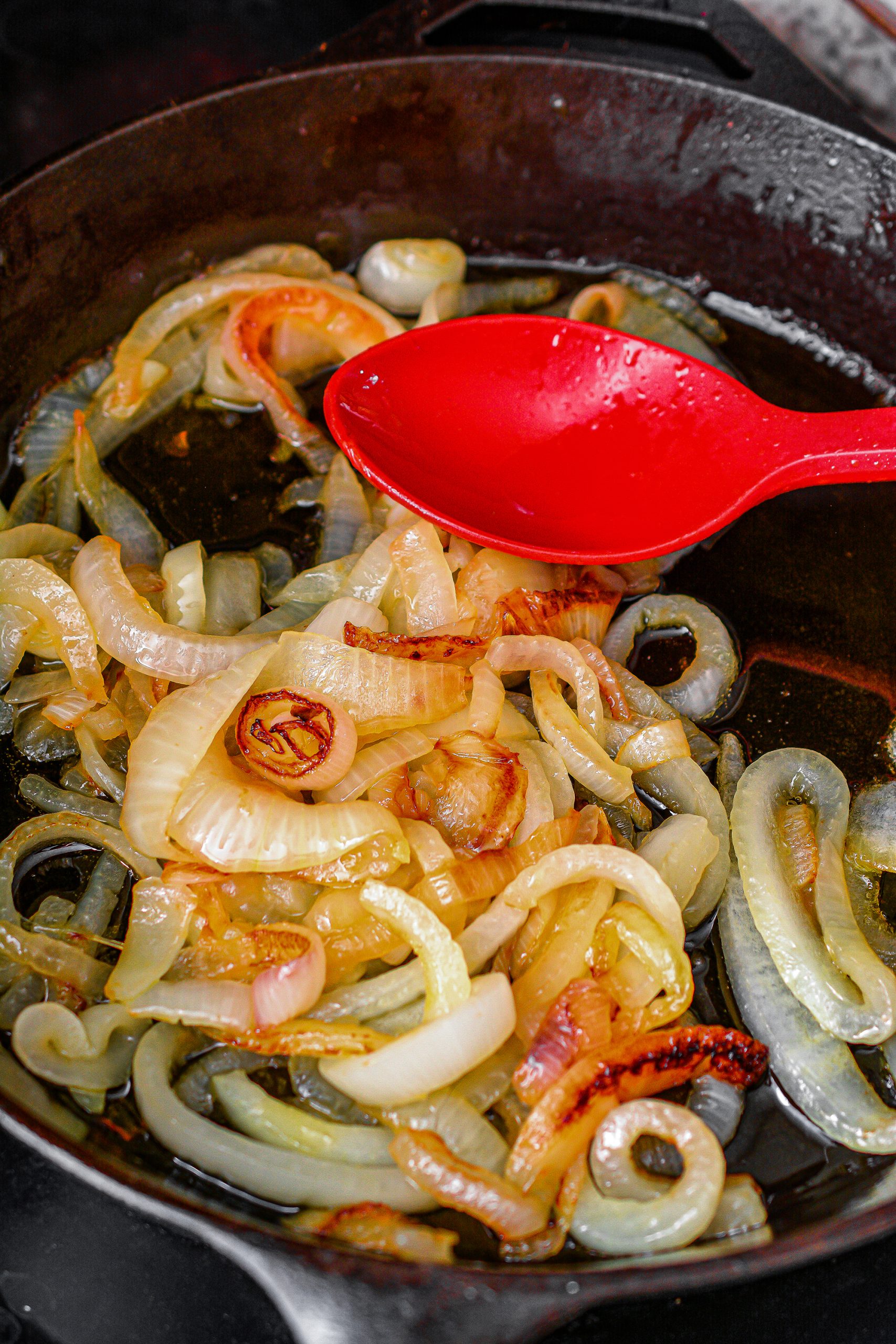 Add the olive oil to an ovenproof skillet over medium heat on the stove, and saute the onions in it until they are caramelized, about 15 minutes.