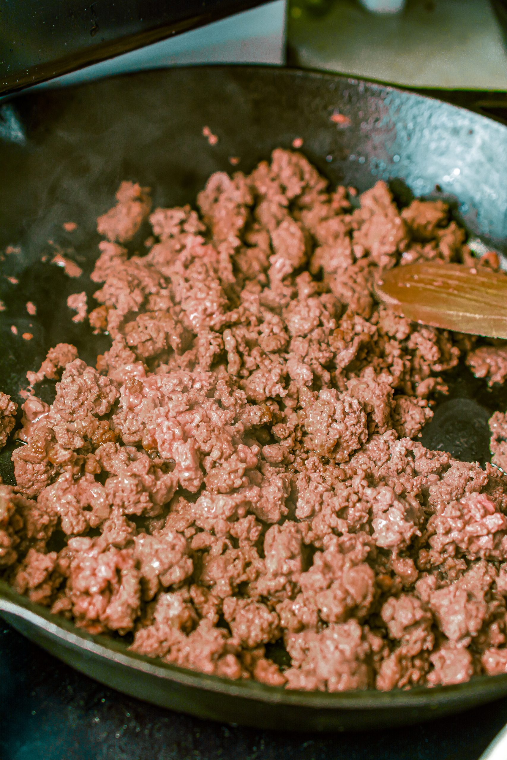 Brown the ground beef in a skillet