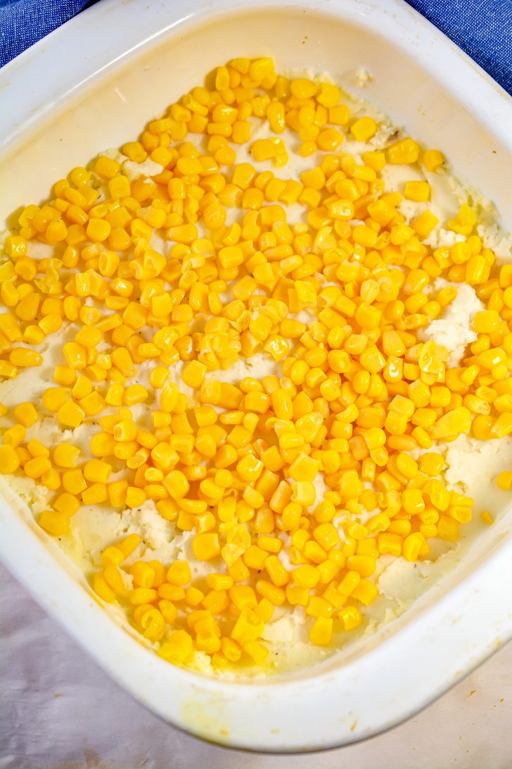 Sprinkle the corn on top of the mashed potatoes.