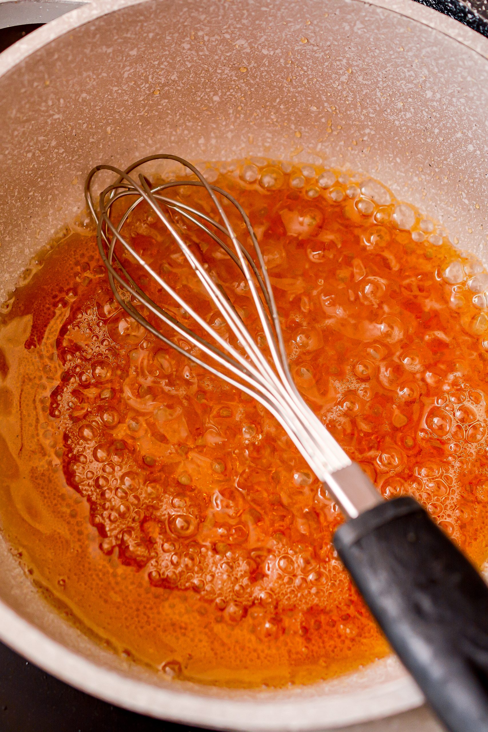 Place the maple syrup in a saucepan over medium high heat and bring to a low boil. Whisk often until the maple syrup darkens, thickens and reaches a temperature of 265 degrees.