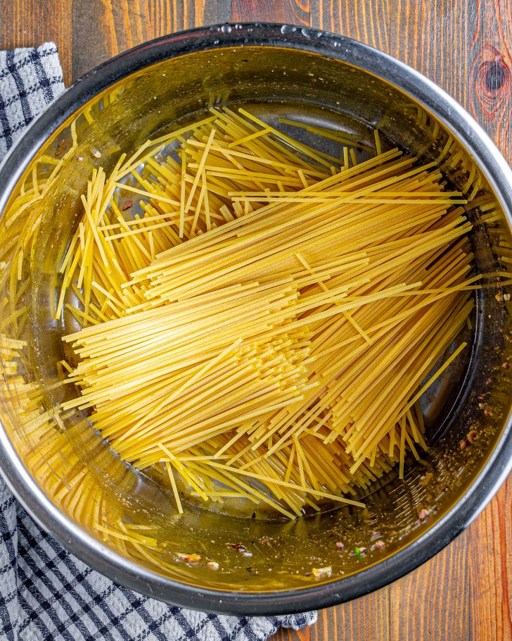 Break the spaghetti noodles in half, and layer them in an “x” pattern in the bottom of the pot. 