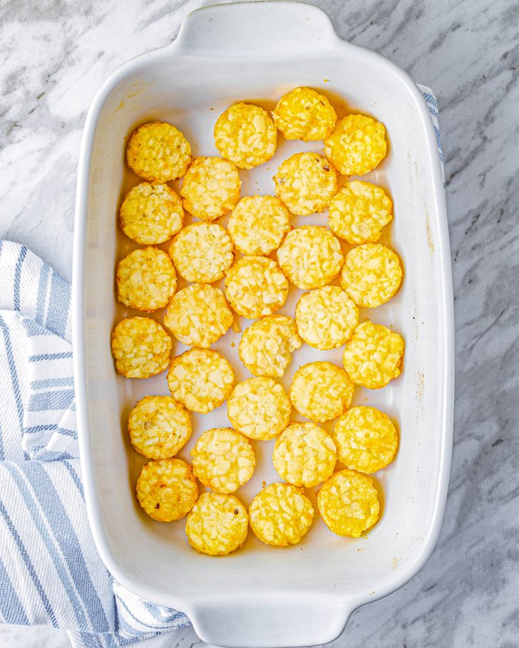 Layer the tater tots into the bottom of the casserole dish and bake for 15 minutes. 