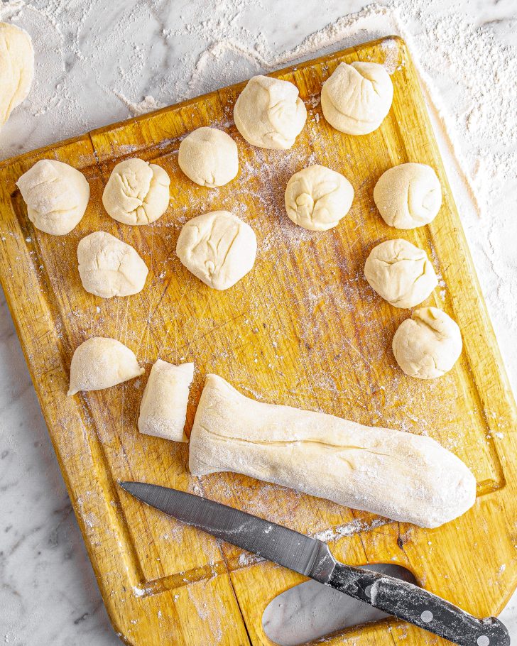 Cut each log of dough into 15 pieces and roll them into balls.