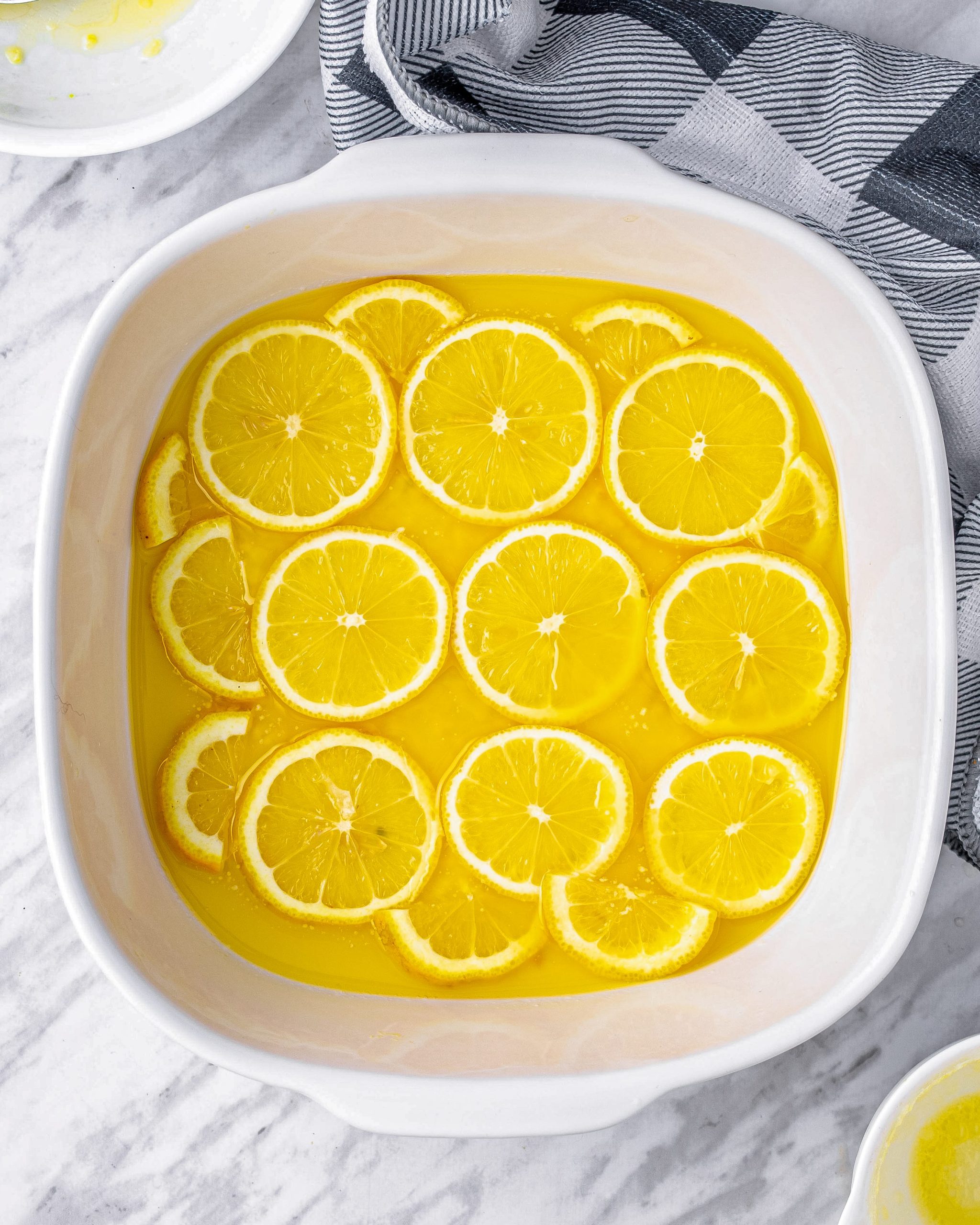 Arrange the lemon slices on top of the butter, forming a single layer.
