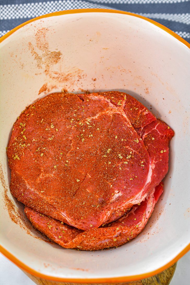 Season the steak with the spice mixture.