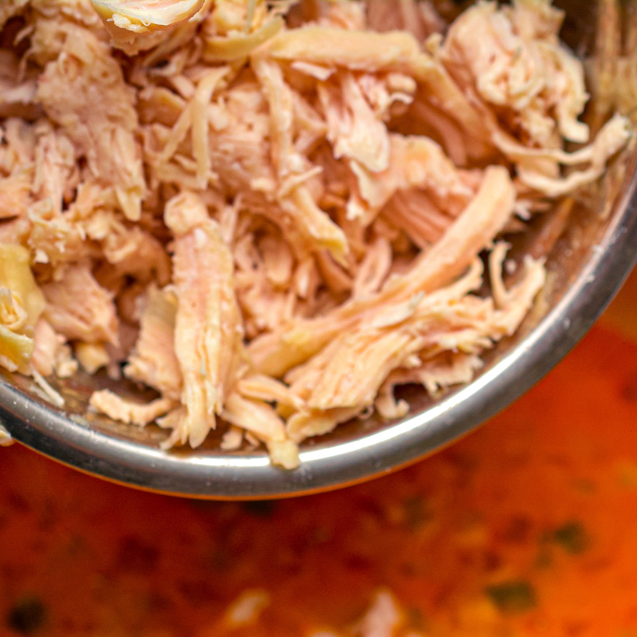 Mix in 1 pound of shredded chicken, and combine well.