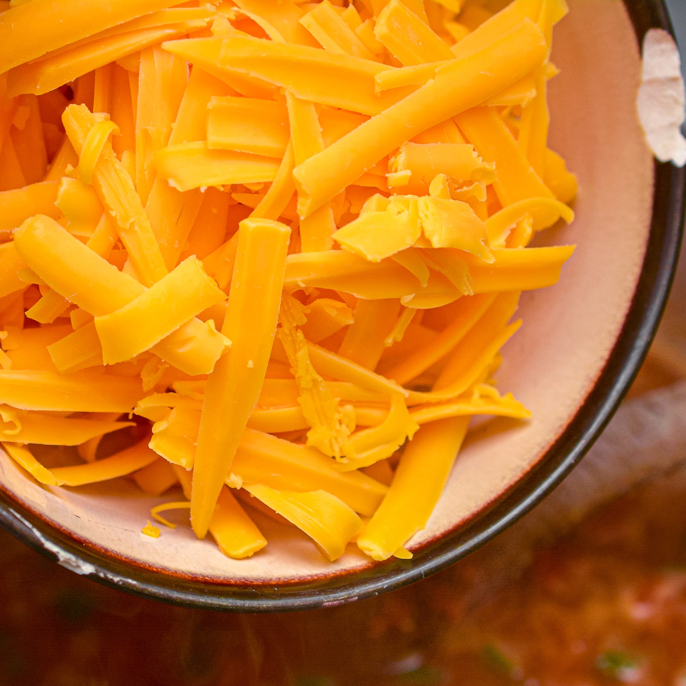 Stir in 2 cups of shredded cheddar cheese, and stir until it is completely melted.