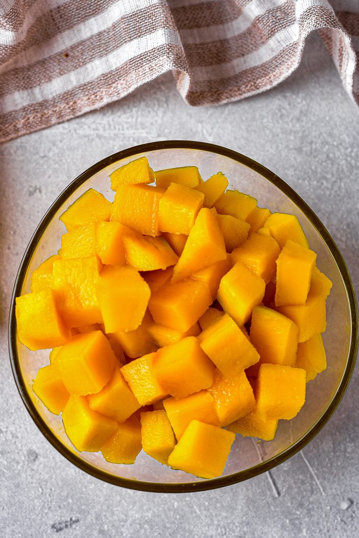 Cut the fresh mango into small pieces and set them aside.