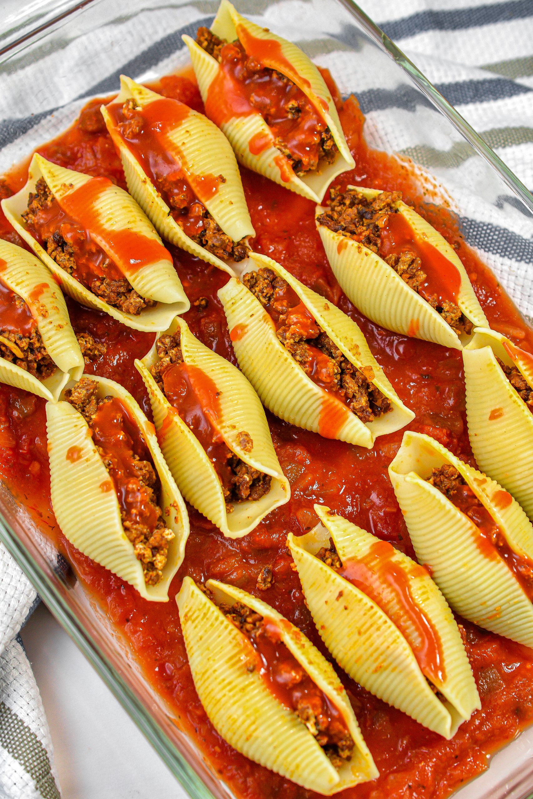 Pour the taco sauce over the shells.