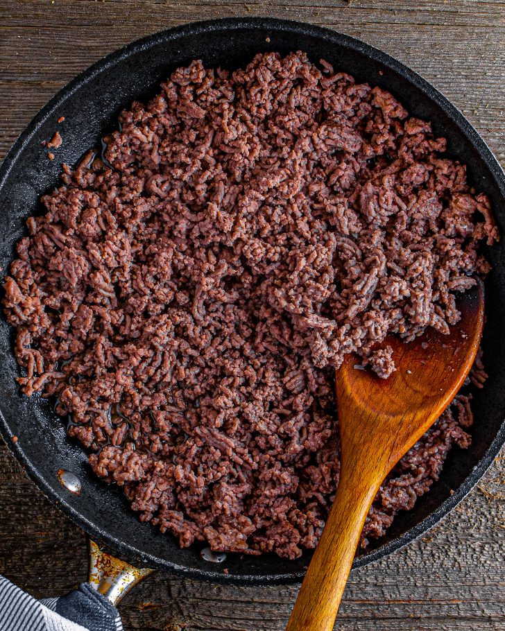 In a deep cast-iron skillet over medium-high heat, brown your ground beef.