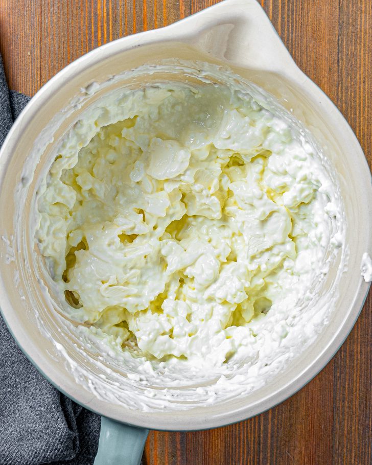 In a bowl, stir together the cream cheese, cottage cheese, and sour cream until well combined.