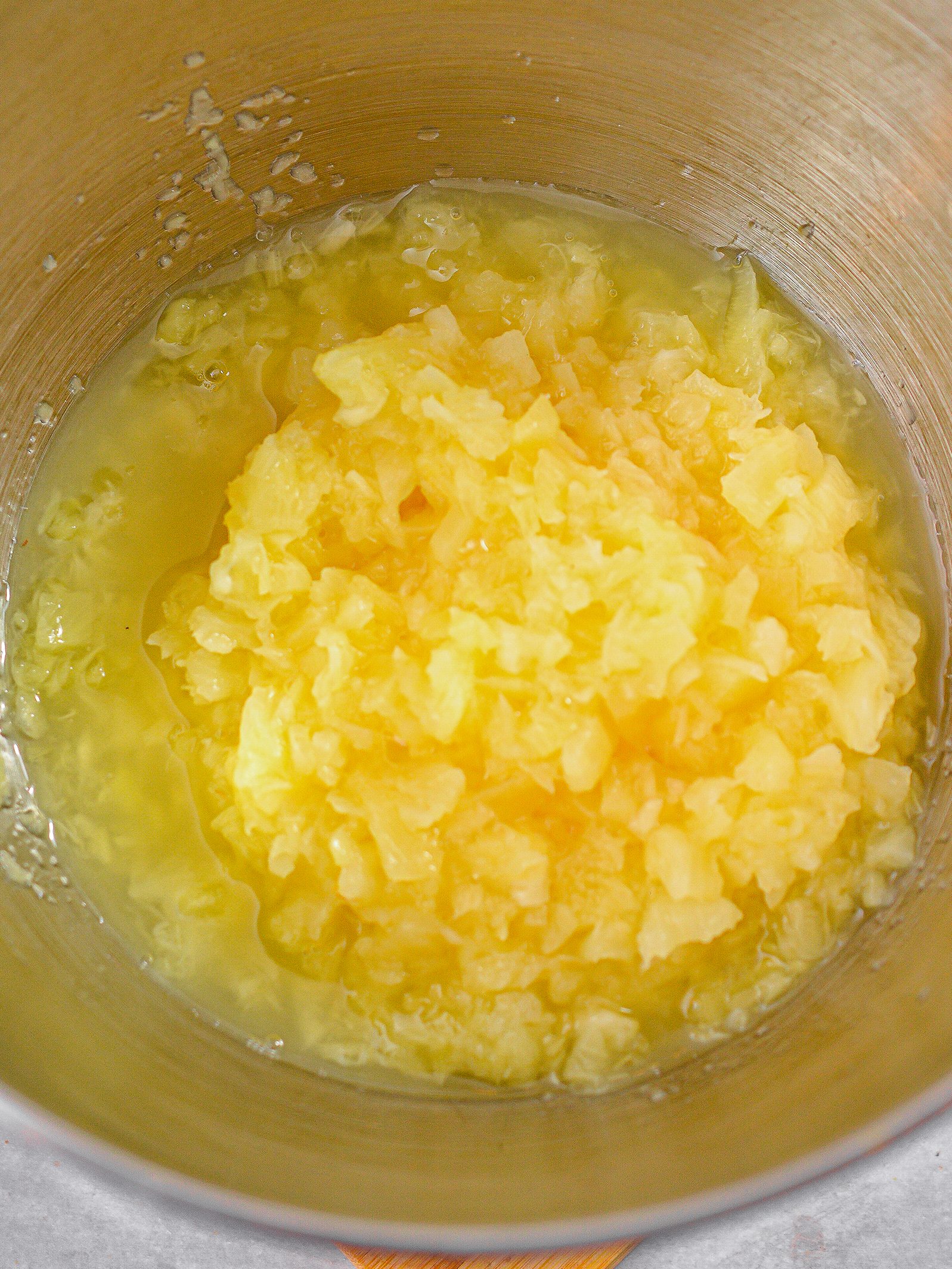 In a mixing bowl, add 1 can of crushed pineapple.