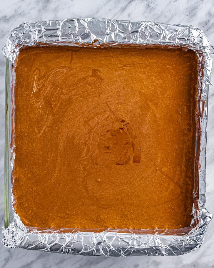 Pour the mixture into a 9x9 baking dish that has been lined with aluminum foil and sprayed with cooking spray.